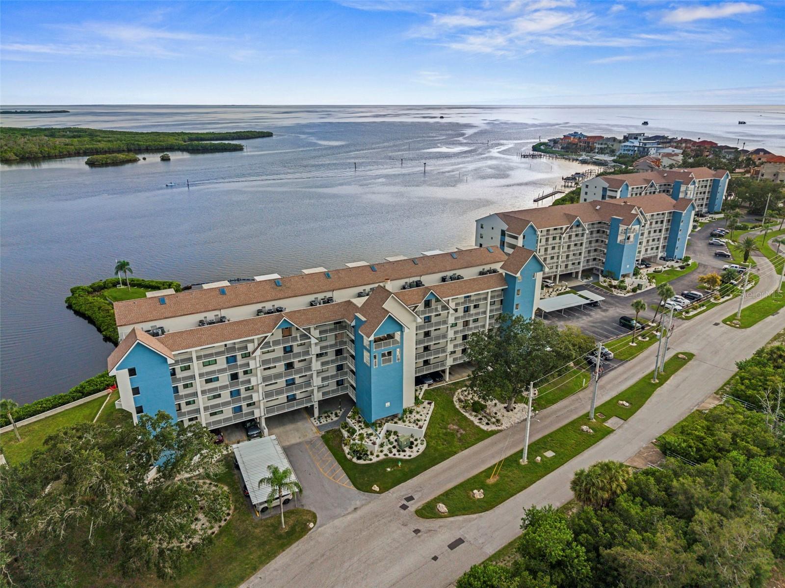 Don't miss this waterfront dream! Unit 1048 is in building 10, conveniently located by the phase 3 pool! Units in this building are about 20% larger than the other units in this phase. Located on the 4th floor this END UNIT has windows on three sides (most units only have front and back windows) so every room is drenched with natural light with windows that offer waterfront or water view from every room.  Kitchen is light and bright with white cabinets, light counter tops, Stainless appliances, built in desk, laundry closet, and wood look vinyl flooring. The great room with windows along the South and West has nice carpet, breakfast bar, wet bar and French door access to the Master bedroom. The interior lanai doors have been removed adding to the open waterfront view and air conditioned sq footage. Master suite with carpet, ceiling fan, large walk in closet, en suite bath with his/her sinks, tub/shower and additional walk in shower. Guest bedroom is carpeted, built in shelving and a large closet. The guest bath has a tub/shower and vinyl flooring. AC 1999, hot water 2008. Hurricane shutters in Master bedroom, dining room and living room windowe. Plantation shutters in all windows. Under building assigned parking. Assigned storage locker.