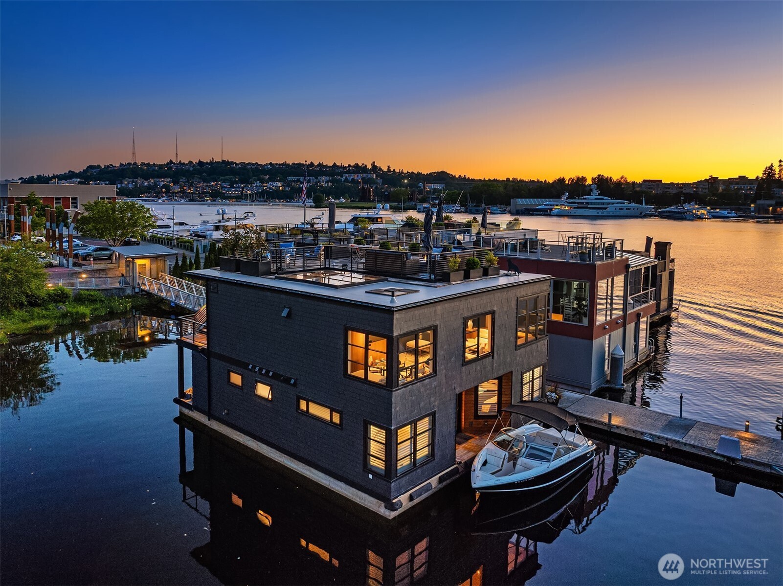 Stunning gated residence in the boutique, 12 slip community of Ward's Cove. State of the art design built by Dyna Construction in 2015 with 30ft steel beams. Second fl Great Room w/Chef's skylit kitchen, top of the line appliances, Custom Walnut cabinetry throughout, cold rolled steel fireplace & corner nano-window reading nook. Main fl. w/3 bedrooms, laundry & moorage for up to 25ft boat. Roof deck w/views of Lake, Fireworks & glorious sunsets. Huge 1200sf basement with tons of storage. Automated blinds, Lutron lighting, Radiant heated tile floors & Geothermal AC thru out. Brand new roof. Gated, secure parking space. Fee simple ownership. One of a kind Lake living in Seattle!