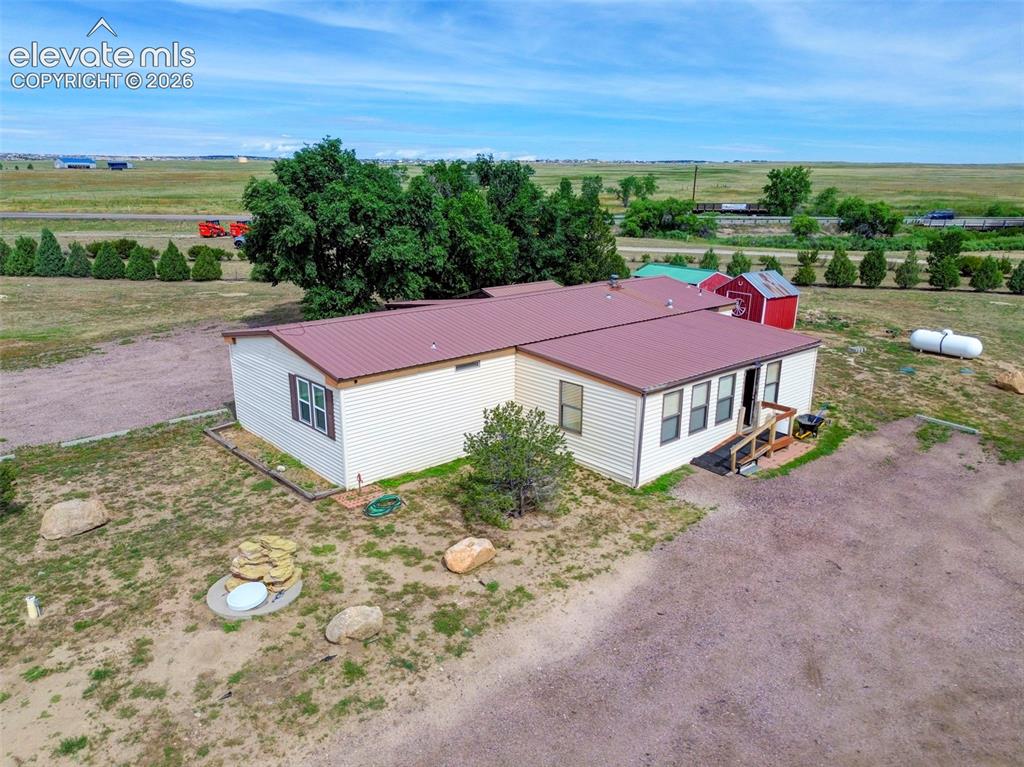 Rare 20-acre property with highway frontage on Hwy 24 in Peyton, CO. Zoned A-35 and legally approved for contractor equipment yard via special use permit (other approved uses are very possible). Includes manufactured home (used as office), 2 large shops (3,000+ sq ft total), 2 wells, 2 septic systems, and 2 electric meters. Second home site is prepped and ready for build or modular. Comes with water rights — subdivision potential. This property offers excellent flexibility for live/work setups or future development. Its highway frontage provides visibility and accessibility, with the surrounding area experiencing significant growth and development. Whether you're looking to expand your business, invest in land with future upside, or develop residentially, this property checks all the boxes.