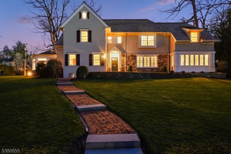 WELCOME TO 55 OX BOW LANE, a re-imagined and fully renovated 6BR, 5.2BA French Colonial nestled on .75 acres in Summit's coveted Northside. A gracious foyer with 9 ft. ceilings, arched openings, custom millwork, leaded glass, & hardwood floors sets a refined tone. The LR with fireplace flows into a sun-drenched sunroom. Across the foyer, a formal DR leads to the renovated gourmet kitchen with heated floors, quartz counters, center island, subway tile backsplash & top-tier appliances - Bosch, Viking, SubZero, Rohl & Miele - plus a walk-in pantry with wine fridge & butler's pantry. The inviting family room adjacent to the kitchen features cherry wood paneling, built in cabinets & fireplace. A renovated powder room, mudroom & attached 2-car garage complete the main level. Upstairs find 6 spacious BR's & 5 renovated baths. The primary suite boasts a spa bath with heated floors, dual vanities, Rohl faucets, soaking tub & steam shower. Each bedroom features ample light & custom closets. The finished lower level includes a media room, rec space, study zone, renovated laundry & half bath. Outside, enjoy a stunning bluestone patio & a private, fully fenced yard perfect for play, relaxation & gardening. The property boasts magnificent specimen trees and countless flower beds. Located just blocks from Summit's vibrant downtown, top-rated schools (Lincoln-Hubbard Elementary School) & the Midtown direct train to NYC, 55 Oxbow Lane offers the perfect blend of luxury, location & lifestyle.