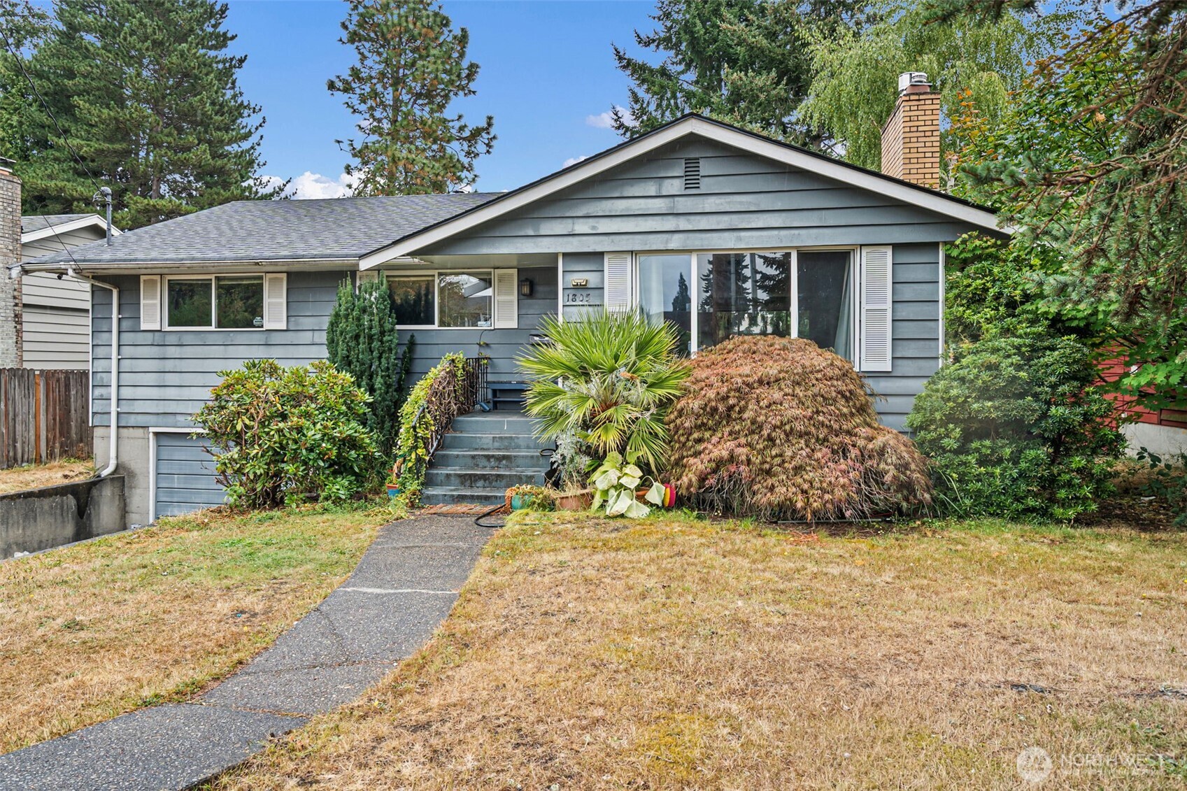Check out this four bed, two bath home in the desirable Westgate neighborhood. You really can't beat the location, just minutes to University Place, the Narrows Bridge, Point Defiance, Ruston, and 6th Ave. The lot is huge, with real hardwoods throughout. A light-filled entry opens into an easy, open living space, and the kitchen overlooks a large backyard that's perfect for summer BBQs. The rest of the main floor is simple and functional, with three bedrooms and a full bath at the end of the hall. Downstairs you'll find a fully finished basement with its own bathroom, spacious enough to work as a primary suite. The roof is only two years old. This one is move-in ready and just waiting for someone to add their own personal touches, giving you real cosmetic upside in a prime location.