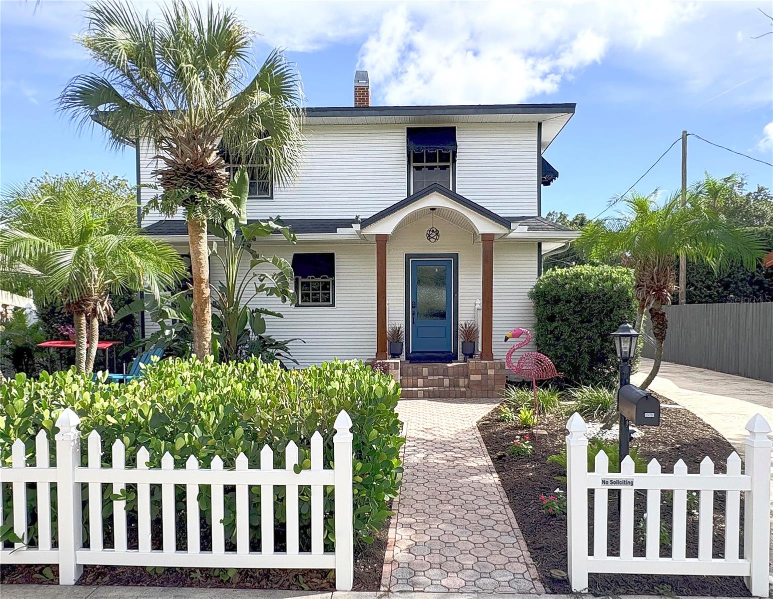 (More photos to come) Why pay new-construction prices when you can enjoy a recently renovated 4-bedroom, 3-bath Colonial home offering 2,074 square feet of modern comfort and timeless character in the heart of Woodlawn, Saint Petersburg.  No flood zone!  From the white picket fence and newly landscaped yard to the inviting front porch with wood pillars and a new front door, this home delivers standout curb appeal. Inside, beautifully refinished original pine floors flow throughout the home, creating a warm backdrop for the open-concept first floor. The living room, dining area, and kitchen connect seamlessly, while a working wood-burning fireplace adds charm and comfort. The renovated kitchen features solid-wood matte-black Modico cabinetry, champagne hardware, neutral quartz countertops with a waterfall peninsula, new tile flooring, updated sink, faucet and lighting fixtures.  A first-floor bedroom with an adjoining fully updated bath offers excellent flexibility for guests or a potential primary suite.  Both interior bathrooms have been extensively renovated. The downstairs bath includes a full tub, glass surround, floor-to-ceiling wall tile, high-end hexagon stone flooring, floating vanity, updated lighting, fixtures, and mirror. Upstairs, the renovated bath offers matte-black penny tile, a floating vanity, wall tile, a large walk-in shower with glass surround, touch-screen mirror and lighting, updated fixtures, and a ceiling fan with Bluetooth speaker.  The spacious upstairs primary bedroom, approximately 12' x 22', features durable vinyl flooring, a walk-in closet, and a powder room. Two additional bedrooms complete the second floor. A third full bathroom off the garage is ideal for rinsing off after a day at the beach.  Outdoor living is equally impressive, with multiple entertaining spaces: a flexible gathering area, a screened/covered patio for relaxing or watching your favorite show, and a 10-person swim spa/jacuzzi with adjustable temperatures from 80 to 103 degrees. The newly landscaped fire-pit area in the front yard is perfect for hosting friends or enjoying neighborhood traditions, including Woodlawn Circle festivities.  Additional highlights include durable vinyl siding, natural gas stove/dryer and tankless hot water heater, a laundry room, raised-bed organic vegetable garden, and HVAC UV light for added air sanitation. Short walk to neighborhood restaurants, cafés, and breweries, including Golden Isles Brewery, Wildflower Ice cream, and Violet Stone Pizza.  Seller is a licensed real estate agent and is relocating to pursue mountain living.