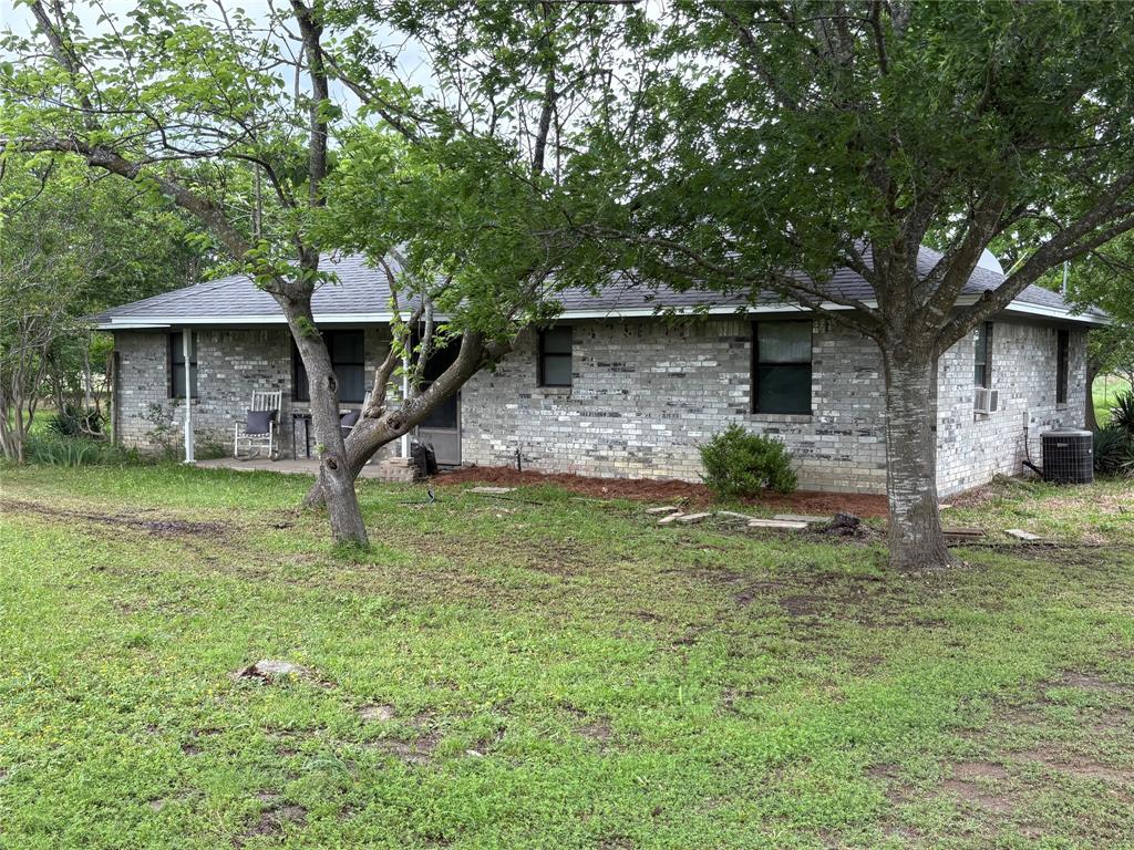 Interior pictures coming soon.Located only 5 miles west of Sulphur Springs is this traditional 3 bedroom brick home on 26.5 ag exempt acres. The house has beautiful wood cabinets, pantry, stove, refrigerator and microwave. The living room features a wood burning fireplace with split bedrooms. A large  12x21' covered patio on the back overlooking the acreage and 2 ponds. The entire property is fenced with cross fence and a few barns for livestock and storage. The 2 ponds allow for adequate surface water in each pasture,  while the acreage provides plenty of grazing for large animals. The large yard contains many types of trees with plenty of room for a garden spot, chickens or a few smaller animals. Located just off Hwy 11 providing easy access  to Sulphur Springs, Commerce or I30.There is plenty of room for an additional home, tiny home or mobile home. NO KNOWN RESTRICTIONS allow you to do it your way.
