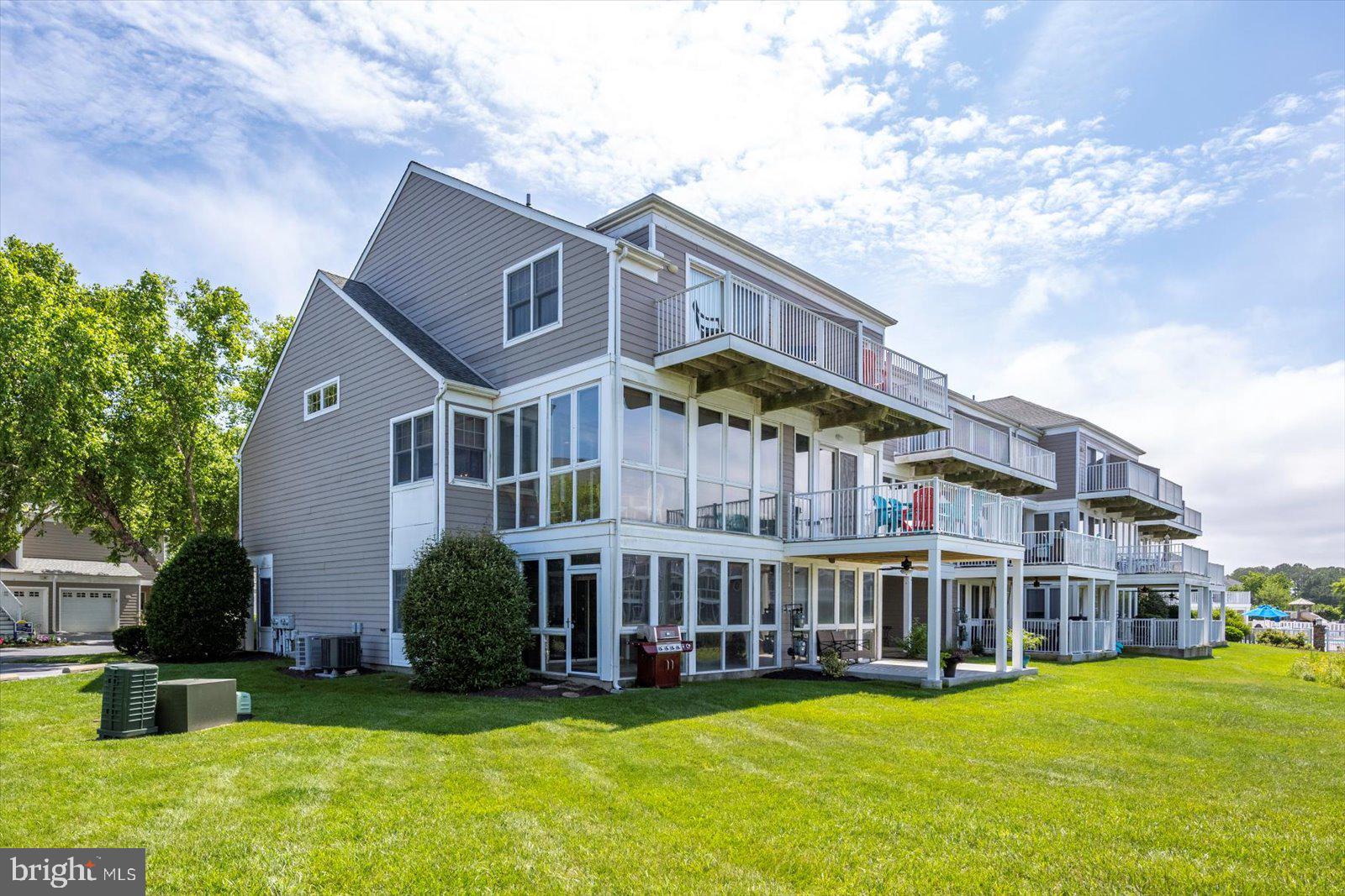 Welcome to 38277 Ocean Vista Dr #1180, a beautifully maintained fully furnished end unit townhome in the sought-after waterfront community of Bayville Shores in Selbyville, Delaware. Ideally located just 2.5 miles from Fenwick Island and minutes to Bethany Beach, Rehoboth Beach, Lewes, and Ocean City, MD, this Court Model offers over 2,650 sq. ft. of upgraded living space with a builder’s bump-out that enhances the open layout and natural light. As an end unit, it enjoys extra windows, added privacy, and unobstructed pond and bay views. The entry level features a spacious guest suite or second primary bedroom with a walk-in closet, en suite bath, and a bright waterfront sunroom perfect for a home office, den, or optional fourth bedroom. The main level showcases 9' ceilings, hardwood-style flooring, and a sun-filled kitchen with skylight, stainless steel appliances, abundant cabinetry, and bar seating. The dining area flows into the living room with gas fireplace and enclosed sunroom offering sweeping views of the pond and Little Assawoman Bay. Upstairs, the primary suite includes a walk-in closet, en suite bath with soaking tub and separate shower, and a private sundeck overlooking the water. A third bedroom with en suite bath and oversized closet completes the upper level. An attached garage provides extra storage, and the home is offered fully furnished with a stocked kitchen—ready for immediate enjoyment. Bayville Shores offers exclusive amenities for homeowners, renters, and guests secured via key fob access. Enjoy an Olympic-sized swimming pool, baby pool, sun deck, and centrally located Community Center with restrooms, showers, and on-site management. The second-floor fitness center includes cardio equipment, free weights, a Pilates bar, TV, kitchen, and community library with stunning pond views. Nature lovers will appreciate three freshwater fishing ponds (catch-and-release), three piers, and a private boat ramp with access to Dirickson Creek and Little Assawoman Bay. Kayak racks are available for seasonal rental, and a private boat storage facility accommodates vessels up to 30 feet. For recreation, there’s a full-sized basketball court, tennis court, four pickleball courts, shuffleboard, horseshoe pits, a sand volleyball court, and a playground. Scenic walking and biking paths wind throughout the neighborhood, with pondfront gazebos, a community post office, and golf cart-friendly roads. Water is included—so you’ll never receive a water bill—and the home is connected to public sewer. Enjoy low electric rates through Delaware Electric Cooperative. The HOA also covers all exterior maintenance plus flood and hazard insurance for low-maintenance ownership. Bayville Shores is partially solar powered, with panels generating over 1.5 million kWh of energy over 30 years. Short-term rentals are permitted, making this a high-performing investment property in a prime coastal location. With beautiful pond and bay views, spacious living, and unmatched community amenities, this turnkey home offers the best of coastal Delaware living.