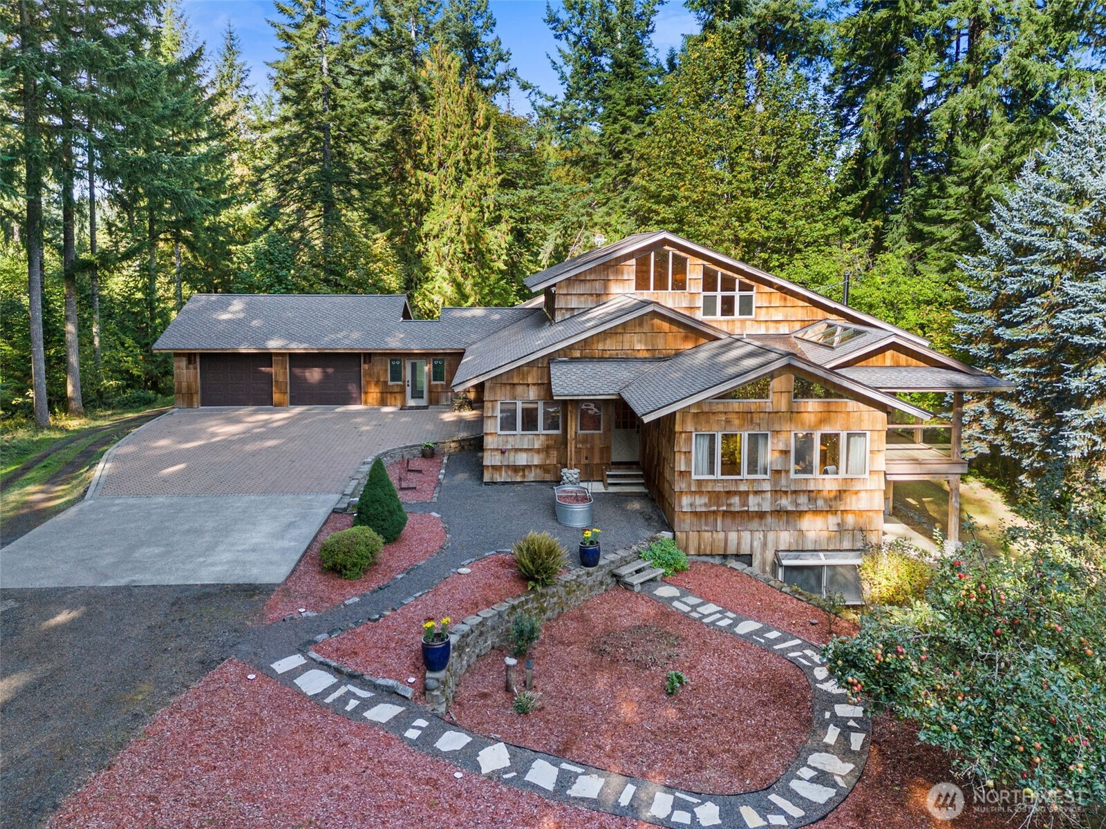Experience luxury & tranquility in this stunning custom home just shy of 7000 sf w/exquisite old growth cedar & curly maple finishes. Main level features a dream kitchen w/dining area, private office, cozy library & primary suite w/spa inspired bathroom. Upper loft offers additional primary suite or extra living area. Lower level boasts an impressive workshop & expansive guest quarters, including a full kitchen & root cellar. On 86 breathtaking acres of timberland w/over $1M in marketable timber, the property has kept grounds, multiple outbuildings & a 5 acre hayfield. Enjoy a lg. orchard, serene ponds, abundant wildlife, & the ultimate peace & quiet that only a secluded estate can provide. This is more than a home, it's a private retreat.
