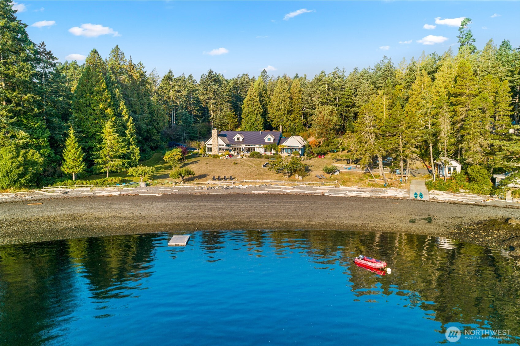 Experience unparalleled waterfront living in this one-level Paulsen custom home, set within a beautiful landscape along one of the San Juan Island's rare private coves. Enjoy the sun rise over the no-bank 330' smooth pebble beach. Mooring buoy and boat ramp,  ideal for kayaking and paddle boarding.  Nearly every room captures sweeping views of San Juan Channel, Orcas Island and the Cascades, making it the perfect place to watch boats and whales, passing by. Light-filled living and entertaining spaces feature soaring 20 ft ceilings, a striking Montana glacier stone fireplace, and a refined neutral palette. Handsome lovely den with fireplace. The chef's kitchen offers honed Pietra del Cardoso stone countertops, 55" La Canache range, Sub Zero refrigerator, and a butler's pantry.  All bedrooms are ensuite, including the luxurious primary suite with spacious bath and private terrace. Blue stone patios and garden paths lead to the expansive lawn, hot tub and a boathouse/writer's studio. A two-car garage with guest suite and gated entry complete this extraordinary offering. 3 additional parcels included to create an exceptional 28+ acre Rocky Bay San Juan Island estate. Development potential on back properties.  Double listed MLS 2437258.