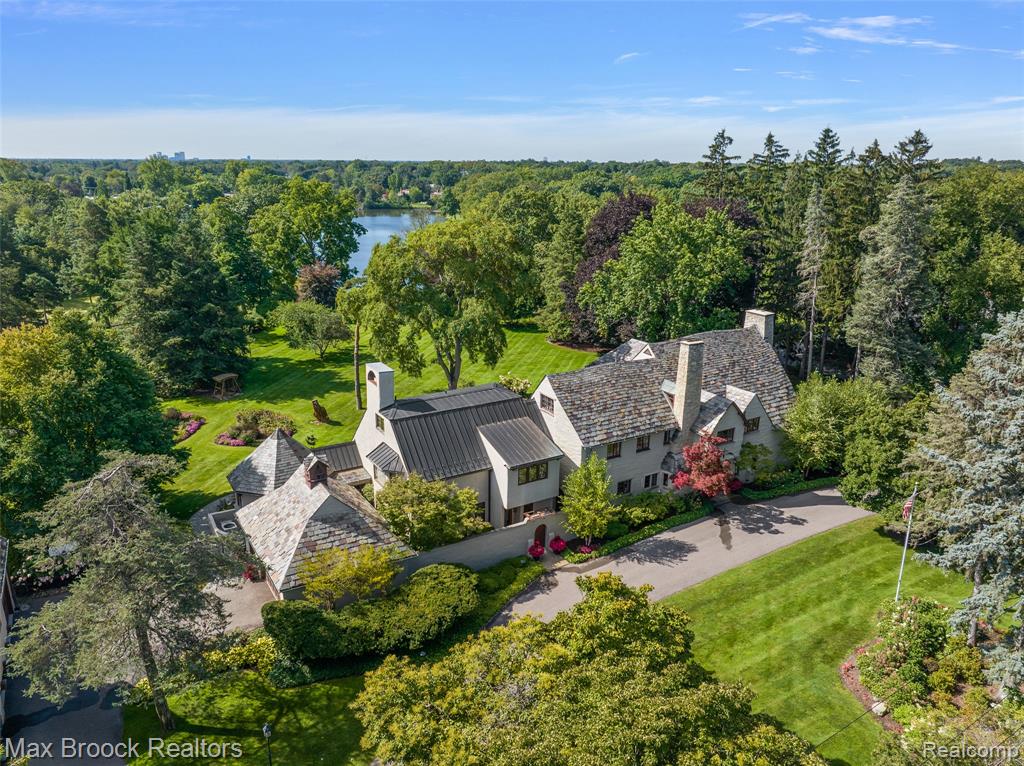 This distinguished 1920s estate, designed by renowned architect Howard Van Doren Shaw, represents a rare opportunity to own a true legacy property. As his only known residential work in Michigan, it holds a unique place in architectural history. Set on 2.5 private acres in prestigious Bloomfield Hills, the property offers serene views of Endicott Lake, framed by meticulously maintained grounds and mature landscaping. The expansive three-story residence spans over 6,800 square feet, with many gracious living spaces. Rich in original detail and character, the home features multiple fireplaces, adding warmth and architectural charm throughout. Additional highlights include a private carriage house apartment and expansive outdoor spaces that enhance the sense of privacy and seclusion. A rare offering, this is a true landmark estate in one of Bloomfield Hills’ most sought-after locations.