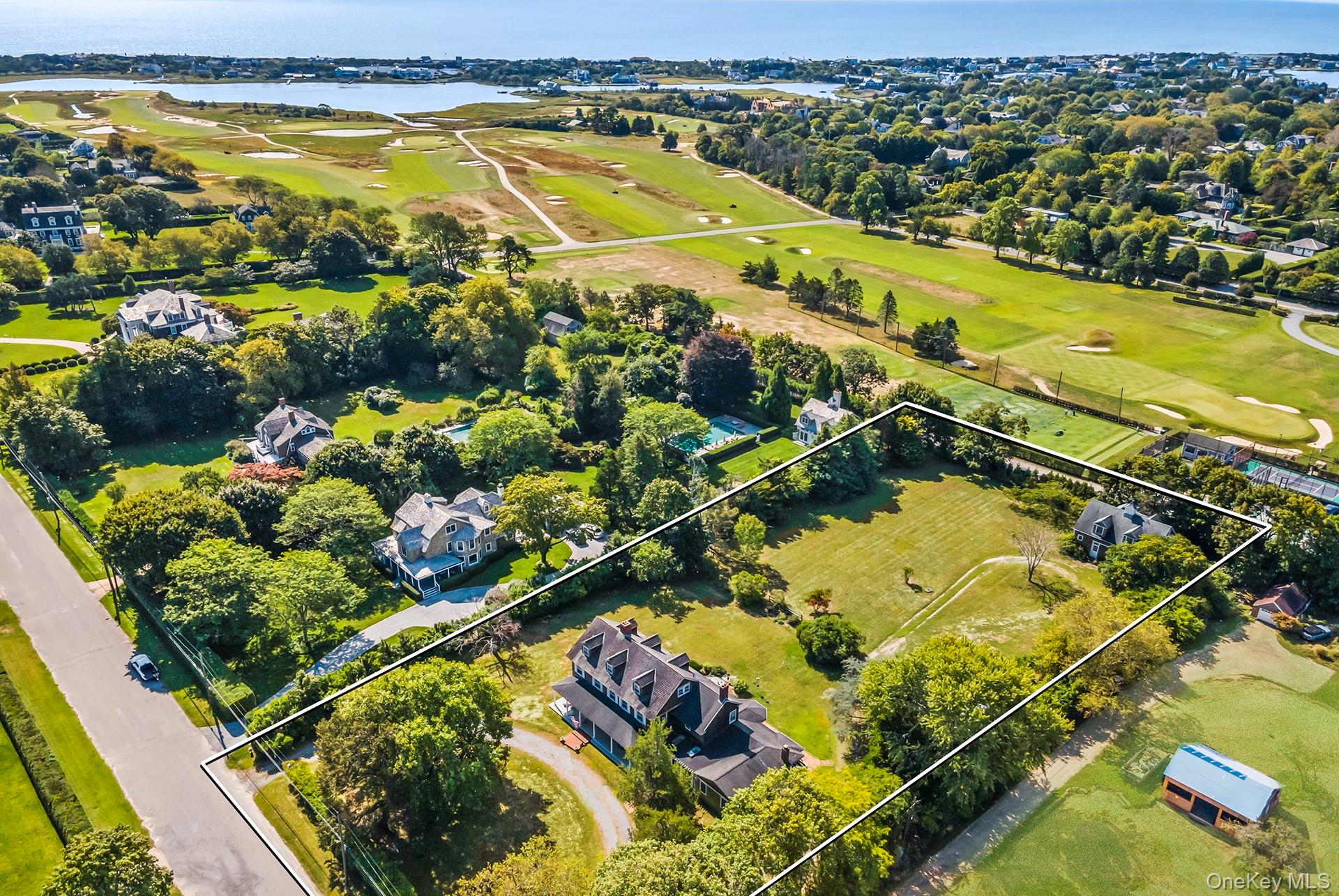 Timeless charm meets endless possibilities at this unique Quogue estate, offered for the first time in five generations. This rare opportunity is located on one of the most desirable streets in the estate section of Quogue South. Originally built in 1890 and sited on 1.98 acres, the property allows for multiple residences. The sprawling grounds feature three separate structures: a stunning, character-rich 5,600+/- sf main house, an 1,850+/- sf barn with a one car garage and a legal two-bedroom guest apartment above it, and a studio (or potential pool house) with a full bath. There is ample room for a pool and tennis court. The historic 7-bedroom, 3.5-bath home blends classic elegance with modern convenience. The first floor includes two living rooms with fireplaces, formal dining room, a sun-filled kitchen with a breakfast room, private office with separate entrance, powder room, and a screened porch. A separate primary suite with a spa bath, walk-in closet, and an attached sitting room with built-in bookcases and fireplace was added in 2000. The second floor hosts six bedrooms, including a lovely primary with a fireplace and an adjoining room that can serve as a nursery, office, or large walk-in closet. An additional third floor, once home to staff, offers endless opportunities. Rich with exquisite period details, including intricate moldings, an expansive wrap-around covered porch, and a stunning stained glass window, this property exudes old-world charm. Whether you're looking to create a private sanctuary or develop a multi-generational compound, the possibilities abound. With its expansive lawns and prestigious location, home to many exquisite estates and the Shinnecock Yacht Club, this unique offering is the perfect choice for those who appreciate history, space and extraordinary potential.