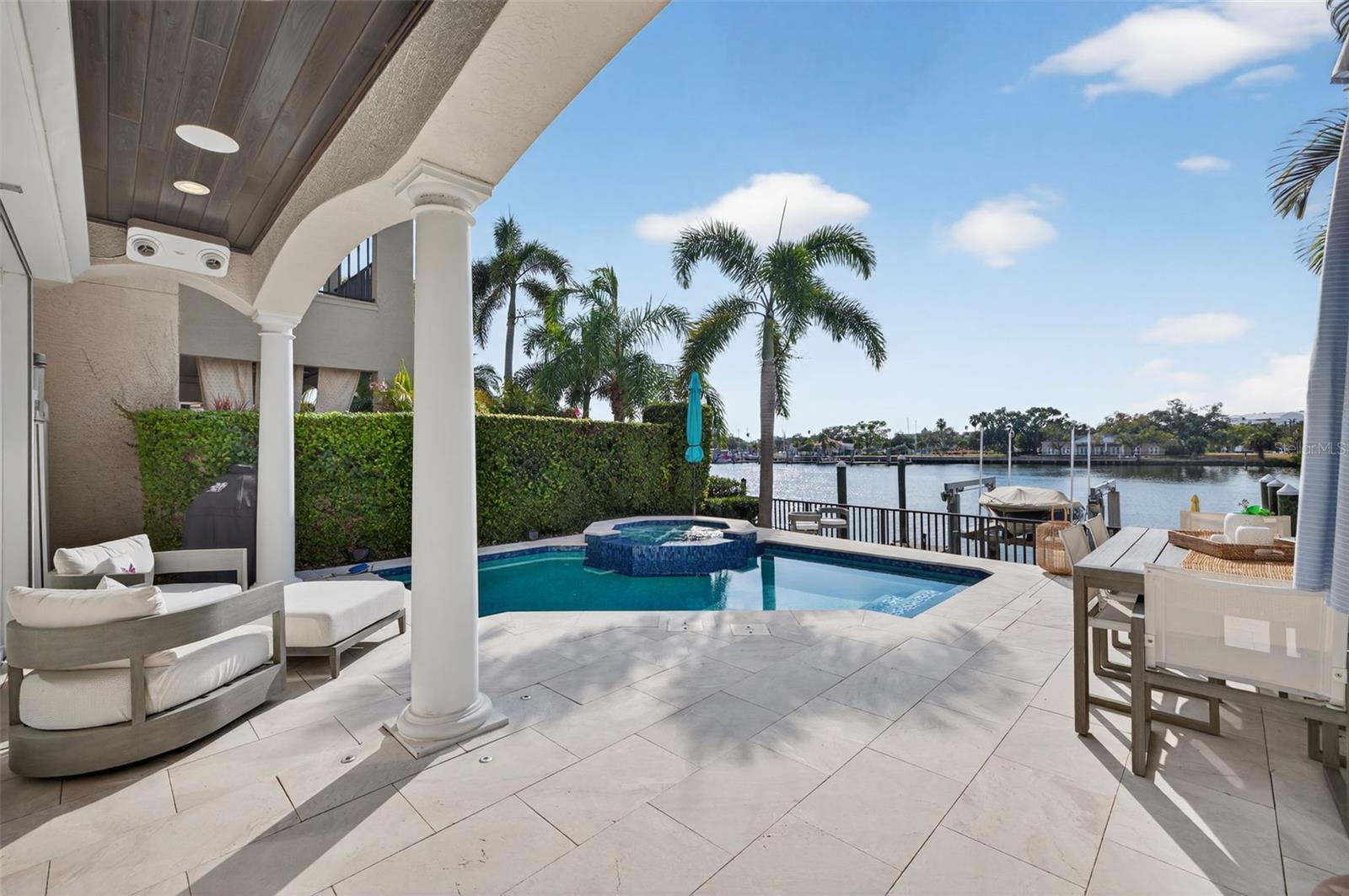 Discover the rare chance to own a luxury waterfront home within Harbour Island’s exclusive 24/7 guard-gated enclave. This fully transformed residence blends refined design with true resort-style living. Wide-plank hardwoods, polished marble, Restoration Hardware fixtures, artisan finishes, and a custom Sub-Zero bar elevate the interior ambiance. The Quartzolite kitchen with gas cooking and premium built-ins enhances both daily living and entertaining.The home features a fully controlled smart-home system, allowing effortless management of lighting, climate, entertainment, and pool functions throughout the property. The primary suite lives like a private spa, offering heated marble floors, a ThermaSol steam shower, and an MTI hydrotherapy tub. Updated mechanical systems include dual A/C units installed in 2018, tankless water systems, an elevator, and a generator-ready electrical panel providing comfort, efficiency, and peace of mind. A new roof completed in 2024 further strengthens the home’s long-term integrity.The outdoor living experience rivals a luxury resort: a vibrant pool and spa, resurfaced deck, updated lighting, surround sound, app-controlled systems, and deep-water canal frontage perfect for enjoying Tampa’s spectacular sunset views. Waterfront amenities include a 16,000-lb boat lift, mounted water-illuminating lighting, an artificial reef, and a refreshed dock.A rare combination of elegance, privacy, security, modern technology, and sunset-facing waterfront living, just moments from Tampa’s top dining and entertainment destinations.