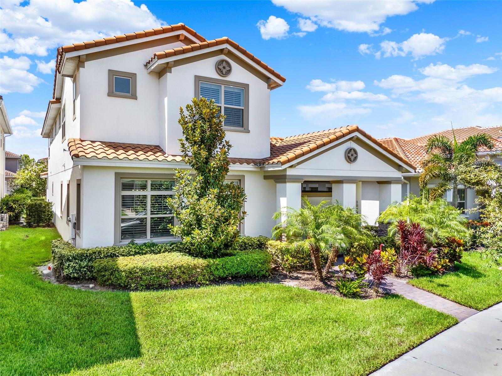 Under contract-accepting backup offers. One or more photo(s) has been virtually staged. *** Bright & Airy Courtyard Home *** Welcome to 10249 Beechwood Lane, a 3,786 sq ft Mediterranean-inspired residence in the guard-gated golf course community of Eagle Creek in Lake Nona. This two-story home offers FOUR bedrooms, THREE and a HALF baths, and a gorgeous open floor plan CENTERED AROUND AN INCREDIBLE SCREENED IN COURTYARD, the ultimate space for outdoor entertaining. From the moment you arrive, the charm is undeniable. Step onto the welcoming front porch, open the gated entry, and you’re greeted by the first of TWO beautiful OUTDOOR LIVING SPACES, a private front courtyard that opens directly to the family room, perfect for relaxing or entertaining. From here, it’s just steps to the home’s showpiece: a spacious screened-in lanai courtyard at the center of the home. Pre-plumbed for an outdoor kitchen and large enough for a pool, this inviting retreat connects to both the kitchen and the primary suite through retractable sliding doors, blending indoor comfort with outdoor enjoyment. The heart of the home is the chef’s kitchen, designed for both beauty and functionality. A massive center island with quartz counters offers seating for casual meals or a place to gather while cooking. Abundant cabinet space, a walk-in pantry, stainless steel appliances, and elegant pendant lighting make it as practical as it is stylish. Natural sunlight fills the kitchen, dining, and living areas, creating the home’s bright and airy feel. Just off the kitchen, a large laundry room offers built-in cabinetry and countertops, while a convenient drop zone by the garage entry keeps daily essentials organized. The first-floor primary suite is a private retreat with DIRECT ACCESS to the main courtyard and a spa-inspired ensuite featuring dual vanities, a large walk-in shower with, and generous closet space. Upstairs, a spacious bonus room anchors three additional bedrooms and two full baths, providing plenty of space for family and guests. Beyond the courtyards, a FENCED BACKYARD offers even more possibilities, ideal for a pergola, play area, or dog run. Living in Eagle Creek means access to championship golf, tennis courts, fitness center, multiple pools, playgrounds, and a beautiful clubhouse. You can walk right our your FRONT DOOT to the nearby community pool or take a golf cart to Eagle Creek Elementary. With easy access in and out of the neighborhood, you’re just minutes from Lake Nona’s shopping, dining, Medical City, and the airport. With its bright, airy feel, two distinct courtyards, and a design that encourages indoor-outdoor living, this home offers the perfect blend of comfort, style, and community.