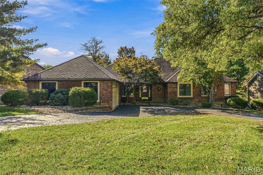 Showings begin Friday, 10/23.  Open house Sunday, 10/25, 1pm-3pm.  Incredible Town and Country location on this 2,551 sq/ft ranch in the highly desirable Cedar Springs gated community.  Appreciate a brisk 5-minute drive to Highways 40 and 141.  Located in a lifestyle community, residents enjoy a two-shift gate attendant, clubhouse, pool, tennis & pickleball courts, scenic pond, and a walking trail accessible from the backyard.  Association provided grounds maintenance for the front and side yard support an already great curb appeal with the brick front elevation, circle drive, and hip roof.  Main level boasts a huge sunken great room with flat-top vaulted ceiling, wet bar, fireplace with marble surround, 6' lookout windows, and deck access.  Eat-in kitchen features a center island with downdraft cooktop, Corian countertops, double sink with window, raised-panel cabinets, wall oven, tile backsplash, and a walk-in pantry with shelving.  Massive master bedroom suite features a fireplace with marble surround and Art Deco-style doors, his & her walk-in closets, and a well-appointed ensuite bath.  Master bath is equipped with his & her vanities, a makeup vanity, large garden tub with tile surround, south facing bay window for a substantial dose of natural light, and a generously sized walk-in shower with bench seat.  Large 15'x12' secondary bedroom on main level has a door to hall bath and a charming window ledge.  The main level is rounded out by a separate dining room with crown mold and chair rail.  Walk-out lower level adds 994+ sq/ft of finish for a total living area over 3,500 sq/ft.  Lower level finish includes a family room with wood-burning fireplace & 6' lookout windows, 2 bedrooms, a full bath with walk-in shower, and a carpeted garment storage area.  Unfinished portion of lower level provides ample storage opportunities, a wine cellar, cabinets, workbench, and a second slider door to access the patio.  Expansive rear patio runs the entire length of the home and connects to a concrete walkway for easy access to the 621 sq/ft garage.  Oversized garage includes insulated doors, workbench, man door, and windows for a small dose of light.  30'x15' deck with composite decking and railings.  Main floor laundry with utility sink.  Lastly, note the home has predominantly wood-trimmed, wood casement windows with metal cladding, and a three-zone HVAC system.  Fresh paint.  New carpet throughout.  Near restaurants and shopping, this centrally located home has a lot to offer new owners.