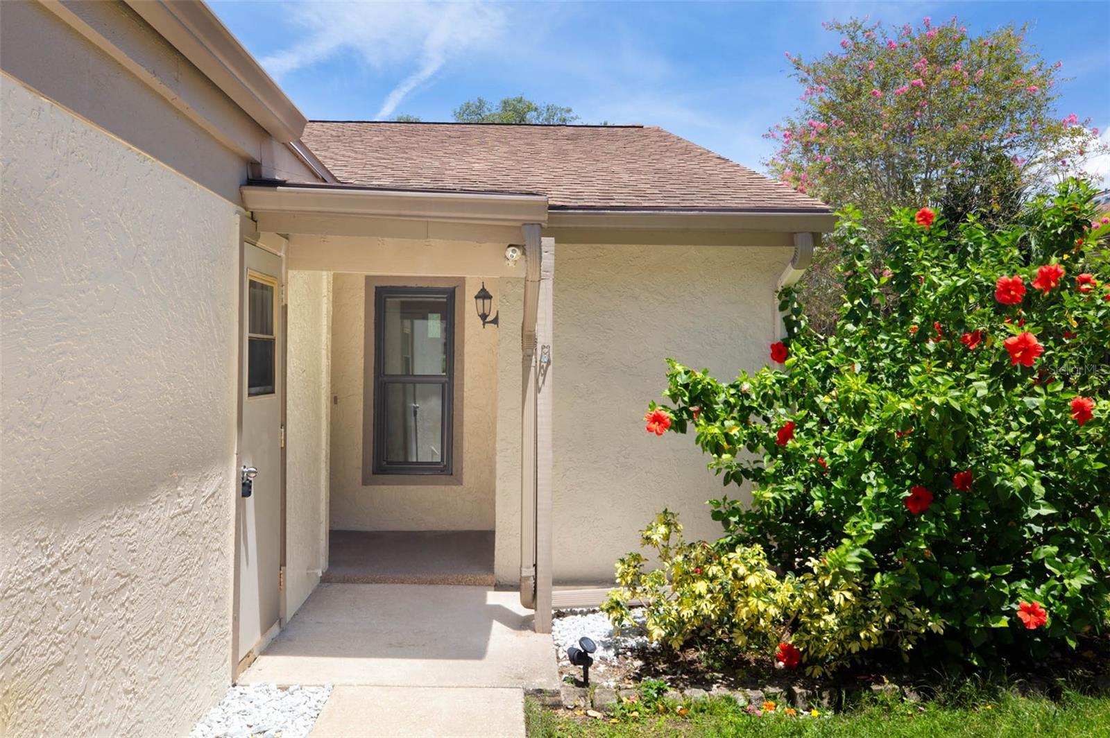 HURRY! This totally renovated 2 bedroom, 2 bath villa with garage and sunroom overlooking the pool will not disappoint.  NEW HVAC AND NEW DUCTWORK 2026. TOTALLY new kitchen with 42" solid wood cabinets with soft close, granite countertops, glass tile backsplash, shiplap ceiling and all NEW stainless-steel appliances.  Refreshed bathrooms and NEW luxury vinyl.  NEW HURRICANE RATED WINDOWS and hurricane shutters for the sunroom (2026).   This 55+ community with a full calendar of events features a clubhouse, fitness center, 2 pools and tennis courts. The desirable location is 7 minutes or less from downtown Tarpon Springs, The Sponge Docks, Pinellas Trail, Sunset Beach, Fred Howard Beach and is adjacent to Tarpon Springs Golf Course.  This truly move in ready villa will not last long!
