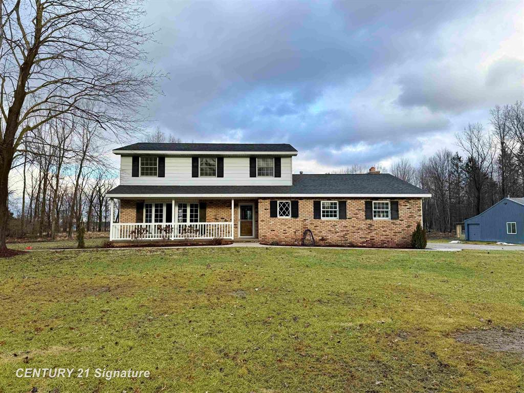 Beautifully updated home in Swan Creek Township! With over 2000 square feet, this property includes 3 bedrooms, 2 1/2 bathrooms, a living room with large windows, a formal dining room, family room with fireplace and access to the spacious yard, first floor laundry, and a kitchen with stainless steel appliances. The primary bedroom boasts an attached bathroom as well as 2 closets. Below is a full partially finished basement with plenty of space for a rec room, play room, etc. as well as plenty of space for storage. This home sits on over 9 acres and features both a barn and a pole barn! The 80' x 40' barn has tons of storage space. The 66' x 40' pole barn is a great workshop setup with its own driveway, bathroom, and finished second story. Call for your private showing today!