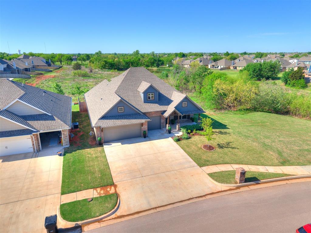 Welcome to your next chapter in Moore—where comfort, technology, and natural beauty come together.

This 2,450 sq ft home offers 4 spacious bedrooms, 3 full bathrooms, and a versatile upstairs bonus room, giving families plenty of space to grow. The thoughtful layout blends open gathering areas with quiet retreats, making it easy to balance busy days and peaceful nights.

What sets this home apart are the views. Backing to a lush green space with no rear neighbors, the backyard feels like a private park—perfect for evenings on the extended patio or cozy nights by the outdoor fireplace.

Inside, high-end finishes meet everyday function. The living room boasts 10-foot ceilings, a stacked-stone gas fireplace, and large windows that frame the greenery outside. The kitchen shines with ceiling-height cabinetry, stainless steel appliances, and beautiful countertops, while the primary suite offers dual closets, a corner jetted tub, and a walk-in shower designed for relaxation.

Smart home technology adds ease to daily living with automated lighting, blinds, and a full suite of included appliances. A tankless water heater, whole-home air purification, and upgraded insulation give you efficiency and peace of mind.

This home is more than a place to live—it’s a lifestyle of modern convenience, family connection, and serene views you’ll enjoy every day.