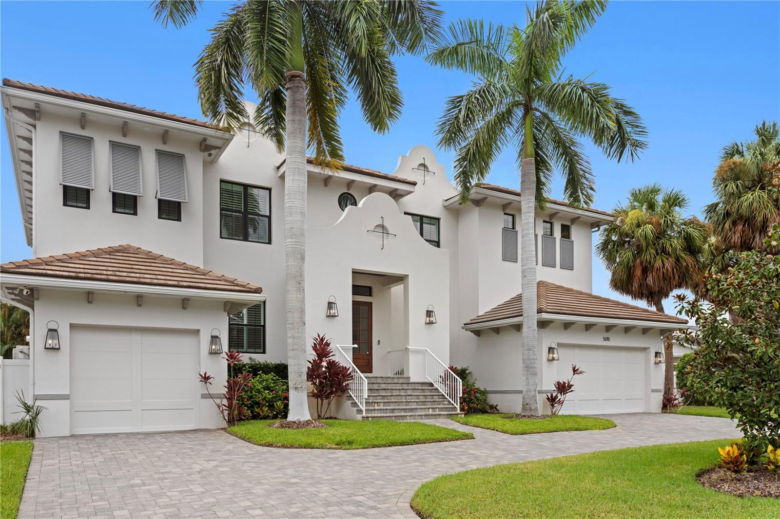 Discover exceptional luxury in this stunning TB Homes residence, perfectly situated on a peaceful Sunset Park street within an A-rated school district. Set on an expansive 80x133 lot, this British West Indies-inspired home offers 5 bedrooms, 4.5 bathrooms, a 3-car garage, and an impressive collection of thoughtfully designed living spaces including a shiplap-accented office/bonus room, elegant parlor with wet bar and fireplace, dedicated gym with rubber flooring and mirrored wall, media room, and private office.Designed for both everyday living and entertaining, the outdoor oasis features a 16’ x 24’ travertine deck, fully equipped outdoor kitchen, beautifully appointed saltwater pool with spa and sun shelf, upgraded pool interior, gas heater, automation system, and a spacious fenced backyard.Built with quality and efficiency in mind, the home showcases superior construction including full two-story concrete block construction, spray foam insulation, and a durable concrete tile roof.Inside, refined finishes elevate every room. Wide-plank oak flooring extends throughout the main living areas and bedrooms, complemented by designer lighting, custom tile selections, chrome plumbing fixtures, smooth drywall, custom ceiling details, 7-inch crown molding, extensive millwork, cased windows, 8-foot solid-core doors, a functional mudroom, and a future elevator shaft. The home is also pre-wired for surround sound, security cameras, and a wireless access point (WAP).The chef’s kitchen is equipped with premium Sub-Zero and Wolf appliances, including a 48-inch dual-fuel range and 48-inch refrigerator. Custom cabinetry with stacked glass upper cabinets, soft-close doors and drawers, under-cabinet lighting, quartz countertops with the elegance of marble, marble herringbone backsplash, pot filler, farmhouse sink, prep sink, oversized center island with additional dining island, butler’s pantry, and spacious walk-in pantry create an exceptional culinary space.The luxurious primary suite offers custom-built dual walk-in closets and a spa-inspired marble bath featuring a freestanding soaking tub and oversized walk-in shower.An extraordinary combination of timeless architecture, quality craftsmanship, and modern amenities makes this Sunset Park home truly exceptional. Buyer to verify all measurements and pertinent information.