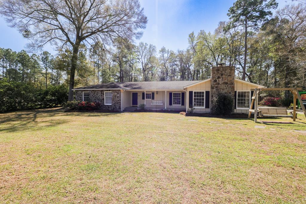 Spacious home located in a quiet established neighborhood in the county but only 10 minutes to downtown Thomasville and less than 5 minutes to the closest Waffle House. This home features 4 bedrooms & 2 bathrooms with approximately 2,115 sf on .6 acre lot. Built in 1976, it has been well maintained with recent updates throughout including new engineered wood floors & carpet, fresh paint interior & exterior and deep cleaning by Zapatas. The exterior has a welcoming cottage style with board and batten siding with flagstone accents and a lovely front porch perfect for swinging in the evening. The floor plan includes a family room with vaulted ceilings, flagstone fireplace, and pine paneling which is conveniently located off the kitchen, formal dining with French doors leading to patio and backyard plus additional living room adjacent to the dining room. The kitchen has solid wood cabinets and hard surface countertops and has a spacious breakfast room off the garage door entrance. The master suite has a large bathroom with tiled walk-in shower and generous walk-in closet. Mature landscaping and plantings include camellias and azaleas. Two car garage has loads of space. Call today to schedule a tour of this property.