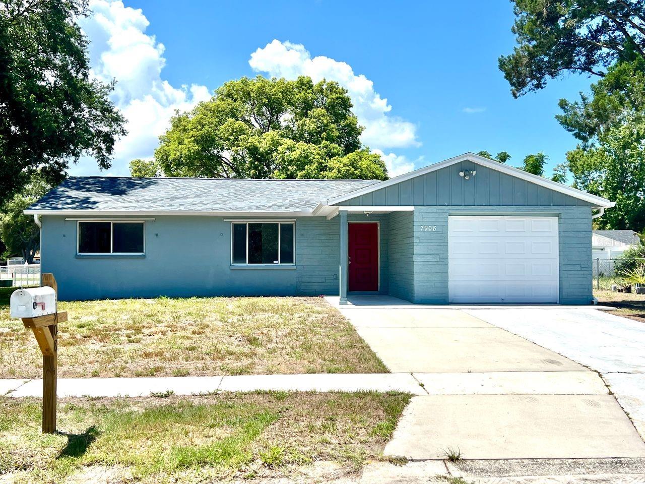 Welcome to your piece of the Florida sunshine in this tastefully updated, move-in-ready home that is perfect as a starter home, relaxing second home, or your forever home for downsizing. This property features 3 spacious bedrooms and two fully remodeled bathrooms, each upgraded with new vanities, brand-new shower stalls, toilets and modern fixtures. Step inside to discover a freshly painted interior complemented by seamless tile flooring that flows throughout the entire living space, creating a clean and cohesive feel. The heart of the home is the updated kitchen, which boasts hardwood cabinets, granite countertops, and large eat in space. Major components offer peace of mind, highlighted by a brand-new roof (2026), updated windows, water heater (2010), AC system (2020), and the benefit of being located outside the flood zone. The exterior features a one-car garage (new door) paired with an extra parking pad for guests or recreational vehicles, all with the freedom of having no HOA restrictions. The fully fenced backyard provides a safe haven for outdoor activities, pets, or gardening. Situated in a prime location, you are just ten minutes away from historic downtown New Port Richey including a wide variety of local restaurants, breweries, shopping centers, medical facilities, and only 40 minutes to Tampa Airport.