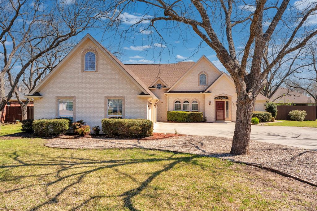 Welcome to this stunning custom-built home in the heart of Pecan Plantation—loved by original owners since 2002 and ready to welcome its next chapter! The open layout seamlessly connects the living, dining, and kitchen areas, perfect for everyday living and entertaining alike. Light, neutral paint colors & beautiful archways throughout. The living room impresses with a gas log fireplace and built-in glass shelves, while the kitchen shines with granite countertops, breakfast bar seating, and a sunny breakfast room. Great dining space so you can host gatherings of any size with ease! Retreat to the spacious primary suite featuring dual vanities, a whirlpool tub, walk-in shower, and an oversized walk-in closet. Large laundry room with sink, cabinetry and granite counters that doubles as a butler's pantry. Two additional large bedrooms and a full bath round out the main floor. Upstairs, discover another large bedroom, full bath, a second living area, and a versatile flex room—space for everyone! Step into the expansive sunroom, then head outside to your private backyard oasis. The large covered patio with tile flooring sets the stage for unforgettable gatherings around a stunning stone fireplace with propane starter and a fully equipped outdoor kitchen—all within a fully fenced yard. Major updates include a new roof 2024, new AC 2023, and new carpet and paint 2022—peace of mind from day one.  So much quality and space at an incredible price! As a Pecan Plantation resident, enjoy 24-7 gated security plus championship golf, multiple pools, tennis and pickleball courts, fine dining, a pharmacy, bank, car wash, and a full-service grocery store—all inside the gates. Come see it. Life happens here!