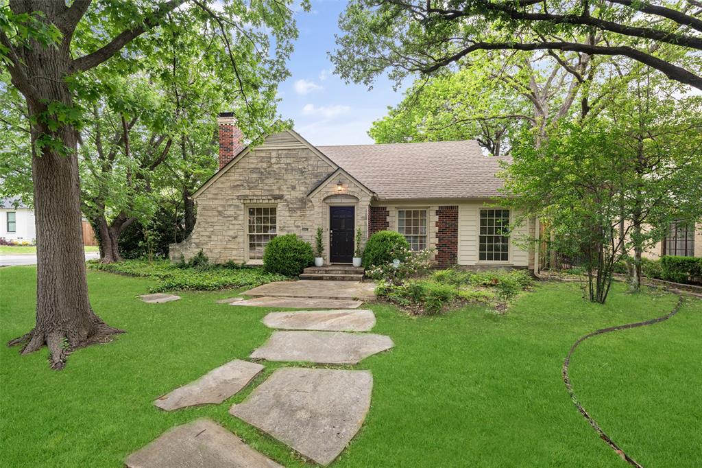 Welcome to prime East Dallas living in this Wilshire Heights Tudor Revival Cottage just steps away from Mockingbird Elementary and Lakewood Village. Surrounded by mature trees on a quiet oversized corner lot, this home boasts beautiful hardwood floors and original touches throughout. The open floor plan features 2 bedrooms and an office, with a wonderful flow of indoor and outdoor living and entertainment. The kitchen opens to a large back deck, which overlooks the turfed yard, a seating area with fire pit, and a dog run all enclosed by a privacy fence.