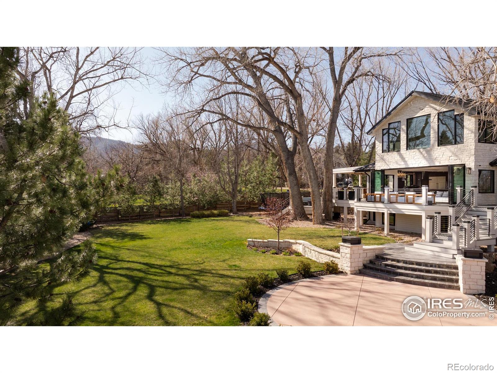 Exquisite secluded sanctuary in the heart of Carolyn Heights. Tucked into one of Boulder's most prestigious enclaves, this estate offers a rare fusion of luxury, privacy, and relaxed sophistication . Set on a serene, tree-lined .81-acre level lot, this 7-bedroom, 5-bathroom oasis is where inspired design meets effortless living. Stunning views of the Flatirons awaken you each morning from your bed. Those same views tease your senses from the expansive patios with fully retractable doors that blur the lines from inside to outside. Bathed in natural light from soaring windows and skylights, every detail has been thoughtfully curated. Custom walnut doors and paneling welcome you into the home and invite you to explore. The chef's kitchen is a showstopper-featuring custom cabinetry, an oversized marble island, and top-of-the-line Thermador appliances. The open-concept layout flows seamlessly into a lush backyard oasis, perfect for gatherings or quiet moments of retreat by the fire pit. The primary suite is a haven unto itself with vaulted ceilings, a spa-inspired bath, spacious walk-in closet, and private deck access. With multiple flexible living spaces-including a dedicated home office and media room, this home is ready to adapt to your every need. Located moments from North Boulder's best hiking trails, cycling routes, farmers markets, and local eateries-yet nestled in the peaceful privacy of a mature, sought-after neighborhood. Elevated living starts here. LIVE BOULDER, LOVE BOULDER! Original home built in 1987. Home had a studs up remodel that was completed in early 2024.