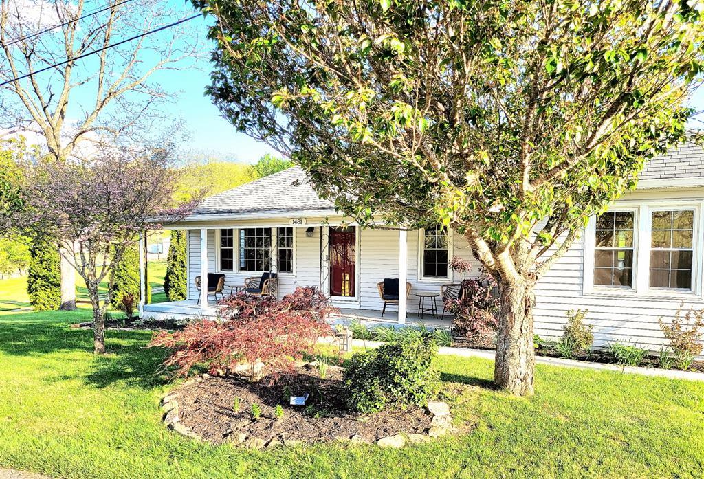 Discover comfort and country charm with this 3 bedroom 2 bath home sitting on 1.24 acres of open pasture.  Ideal for horse enthusiasts or anyone seeking peaceful rural living with access to scenic riding opportunities with location close to Jefferson National Forest and Virginia Highlands horse trails.  Inside you will find easy care and convenience with new paint, hardwood and tile floors with carpet in bedrooms, spacious kitchen with new countertops and views out over the property along with a separate dining room. The home offers a unique waterproof laundry room that leads to the open back deck.  The second bath has an open room shower offering easy access.  The full walkout  basement would be great for storage or a work area.  Step outside and you have a detached garage/workshop with plenty of space, an area that makes a great chicken coop and a barn that is ready to go with the animals or hobbies that has electricity. Around the house you have apple, pear and cherry trees along with beautiful landscaping to offer a picturesque setting.  Make your appointment today for this property that is ready to go inside and out and enjoy your days lounging on the covered country front porch instead of working on a home.
