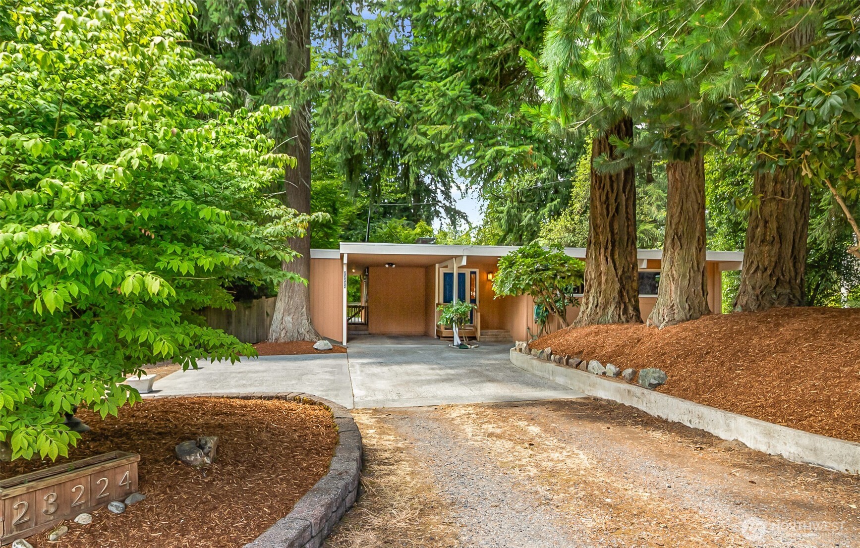Meticulously maintained 1,772 sq. ft. daylight rambler. Beautiful "treehouse views" of landscaped shy 1/2-acre lot. Expansive living room with wall-to-wall bank of large windows bring in the gorgeous, serene views of the private backyard. 3 bedrooms on main floor w/full bathroom. Lower bedroom has a 3/4 bath & door to covered patio. Kitchen w/gas cooktop & breakfast nook. 750 sq. ft. Trex synthetic easy-care deck, several large concrete patios, great for entertaining & relaxing, Fenced park-like private yard. Hardwood floors throughout main floor, skylights, double paned vinyl windows & new hot water heater. 2 fireplaces (main flr frplc is a gas). Fresh interior paint. Great neighborhood, near schools & easy freeway access.
