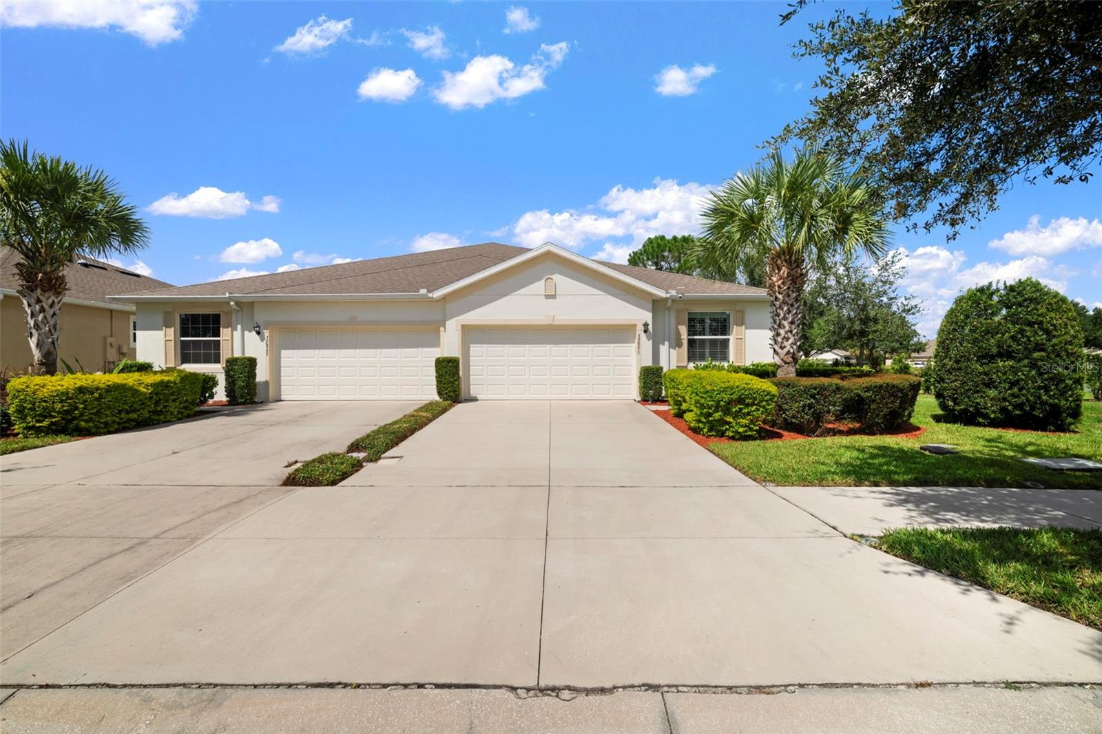 This beautifully upgraded end-unit villa is move-in ready and full of thoughtful touches. Inside you’ll find granite countertops in the kitchen and bathrooms, plantation shutters, upgraded fans and fixtures, a stylish kitchen backsplash, and vinyl flooring in the bedrooms. The master closet is custom built, the garage has overhead storage, and the fenced backyard with a screened-in back porch is perfect for relaxing. Plus, enjoy the convenience of a water softener and reverse osmosis filtration system.

The Watergrass community has it all—3 pools, fitness center with playroom, tennis courts, dog park, splash pad, and a clubhouse you can rent for private events. Families will appreciate the on-site elementary school and golf cart friendly community.

Enjoy low-maintenance living with HOA covering your roof, exterior paint, pesticide services, irrigation and lawn maintenance!

Live close to it all—Publix, Starbucks, and Chick-fil-A are under a mile away. With the new I-75 entrance on Overpass Road, The Grove, Wiregrass Mall, and Tampa Premium Outlets are just a short drive!

Don’t miss the chance to call this home yours!Quick move in available