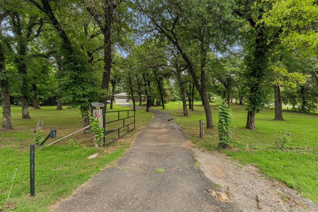 Nestled on just under 3 wooded acres in a highly desirable location and Edmond school district. Property is zoned AA (agricultural) and presents a rare opportunity to create your dream estate. A winding drive, gated entrance, gorgeous mature trees, and expansive grounds provide a private setting with endless potential. The existing residence is being sold AS-IS, with the value primarily in the land. Whether you choose to renovate, rebuild, or develop your vision, opportunities like this are few and far between.