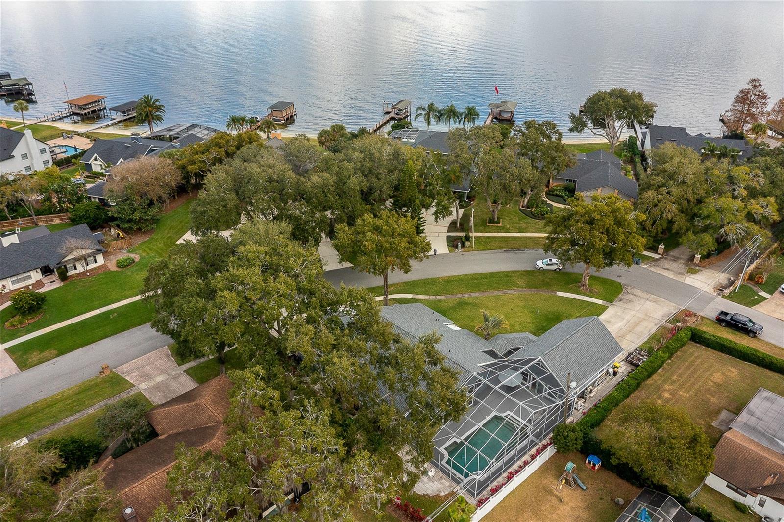 Beatiful high tongue and groove wood celings welcome you into this 4 bedroom 2 1/2 bath home. Enjoy a hot summers day on the huge screened in pool and patio area with breeseway access to the seprate mother in law suite. This guest suite has a quaint kitchen with a half bath making it perfect for a pool bath and  patio hangout. Upstairs you can have a fitness room or bed room. Back to the main house, the spacious kitchen with high celings and a ton of cabniet space will make any chef in the family jealous. The open family room is the star of the show.  Sliders open to the pool area and light poors in through the multiple windows. The elagant dinning space is connected to the kitchen and formal living room. The master bedroom is larger than most in this area with a walk in closet, spacious shower, and split floor plan for privacy. Additionally there are 3 bedrooms on the other side of the house and a large laundry room. Do you need a space for your hobbies and cars? You have tons of space for that here! One 2 car garage is attached to the home and a seprate 2 car garage is located next to the pool. If you are looking to have fun on the lake, the location could not be better. Directly accross the street is the HOA private boat slip. Back your boat directly from your driveaway into the lake! Belle Isle is a tight knit community within Orange county with lots of family activities, parks, and of course the Lake Conway chain of lakes. Belle Isle has its own police force and govnerment officals while also being very close to the airport, Flordia Mall, and Beachline expressway. This city is tucked away from the rest of Orlando keeping its charm and beauty reserved for the residents. Come see why this homes location stands out from the rest with the city, the oversized .4 acre corner lot, and direct access to the boat ramp and park.