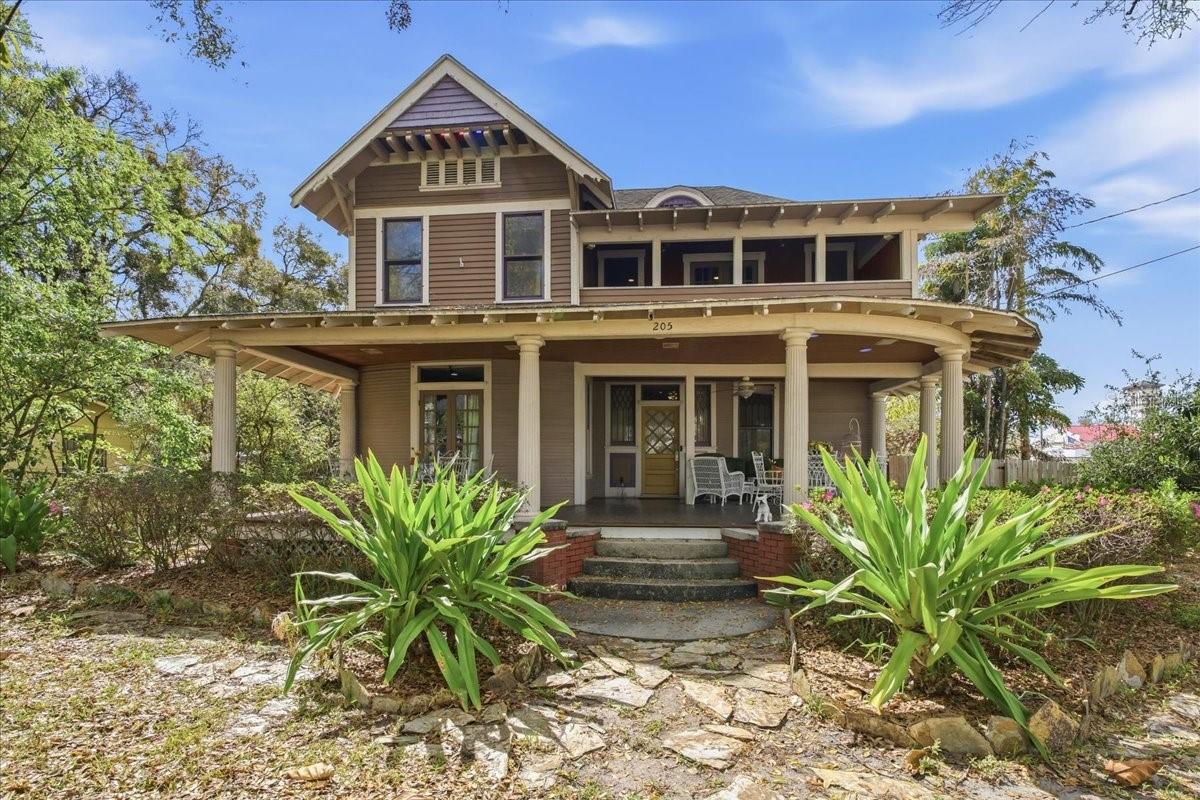 Under contract-accepting backup offers. Step into timeless character and architectural charm at 205 E Park Ave, located just minutes from downtown Tampa. This unique 4-bedroom, 2 full bath and 1 half bath home offers a rare opportunity to own a piece of Tampa history while enjoying spacious living and an unbeatable location.From the moment you arrive, the home’s classic curb appeal stands out with its expansive wraparound front porch, stately columns, and inviting Southern-style architecture. Perfect for relaxing evenings or entertaining guests, the porch sets the tone for the warmth and character found throughout the home.Inside, you’ll find hardwood floors and high ceilings that highlight the home’s historic craftsmanship. The welcoming foyer leads to generous living spaces including a cozy living room with fireplace, a formal dining room with beautiful historic windows, and multiple flexible rooms that can serve as bedrooms, offices, or creative spaces.The kitchen offers ample cabinetry and workspace, making it ideal for everyday living or hosting gatherings. Upstairs and throughout the home, large windows fill each room with natural light while maintaining the property’s classic aesthetic.Whether you're searching for a distinctive primary residence, a historic restoration opportunity, or an investment in one of Tampa’s most desirable areas, this property offers incredible potential and timeless appeal.