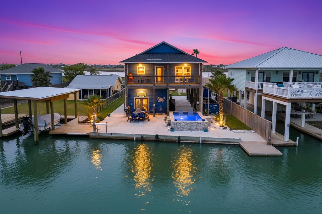 Welcome to your dream coastal retreat&mdash;where luxury meets laid-back waterfront living. This stunning 3-bedroom, 3-bath home is perfectly positioned along a serene canal, offering breathtaking water views right from your backyard. Designed for both relaxation and entertaining, the outdoor space is a true showstopper. Take a dip in the custom pool, complete with heater and chiller for year-round enjoyment, or unwind on the shaded back deck as you overlook the peaceful coastal waters. Anglers will love the private dock equipped with green underwater lights&mdash;perfect for night fishing right at home. Inside, every inch of this home reflects thoughtful design and high-end coastal finishes. The expansive kitchen features a large island, custom cabinetry, and stylish details that make it the heart of the home. The dcor throughout is nothing short of exceptional, blending comfort with elevated coastal charm. Need extra space? The &ldquo;man cave&rdquo; garage includes a full bathroom with a mini split and sits just steps from the pool area&mdash;ideal for entertaining or hosting guests. Plus, a convenient elevator/lift makes transporting groceries, large items, or accommodating guests effortless. Spend your days soaking up the sun poolside or casting a line off the dock, and your evenings enjoying the coastal breeze under the stars. This is more than a home&mdash;it's a lifestyle.