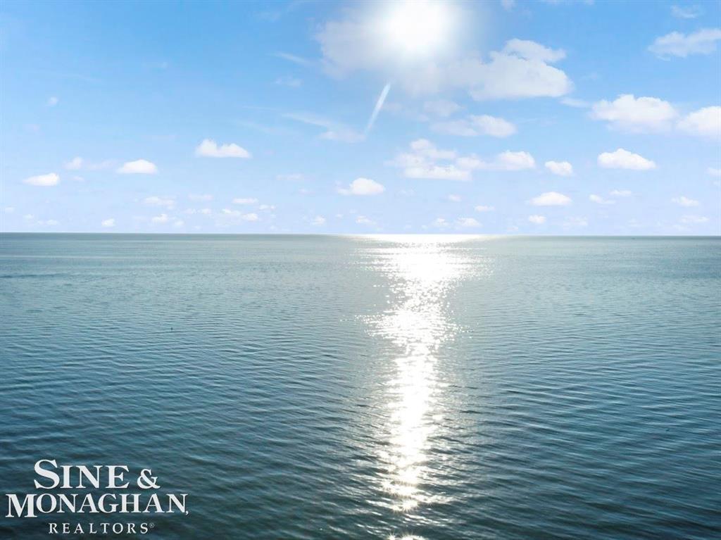 Nautical Mile Gem! Stunning waterfront opportunity with 132.5' of frontage and direct lake access on Lake St. Clair, protected by a 132.5' steel sea wall. The property features approximately 1.4 acres, a 200 ft dock, extensive new cement work, and an extraordinary 4,329 sq. ft. garage complex-unlike anything else on the lake. With 9-10 stalls, multiple 8' overhead doors into areas with roomy 10' ceilings, and a mega-sized RV bay (29' wide x 56' deep x 15'- ceilings, 14' OH door), this is a dream setup for car collectors, RV & boat owners, or anyone needing an unmatched storage & workspace capacity. The garage space includes approximately 3,741 sq. ft. attached plus 588 sq. ft. detached. While the residence allows room for updates, the seller has strategically priced at $1,339,000 based on land value, waterfront, dock, and brand-new garage enhancements including one full bathroom (stub-in prepped) plus extra-wide stairs to the approximate 2,371 sq. ft. of bonus space prepped above (with inviting vaulted ceiling areas). A rare chance to secure premier Lake St. Clair waterfront living with one of the largest garage facilities in the area. All within walking distance of restaurants, parks, new city Activity Pier, newly renovated city pool plus a new bath house in the Spring 2026, and shops. Just 5 minutes to access I94 & 696. This great family community is situated close to everything but still feels as peaceful as northern Michigan without leaving the city. Driveway accessible from a safe and quiet residential street. Only 25 minutes to visit metropolitan attractions, sporting events, concerts, casinos, entertainment & restaurants in downtown Detroit/Canada, Royal Oak & Novi.