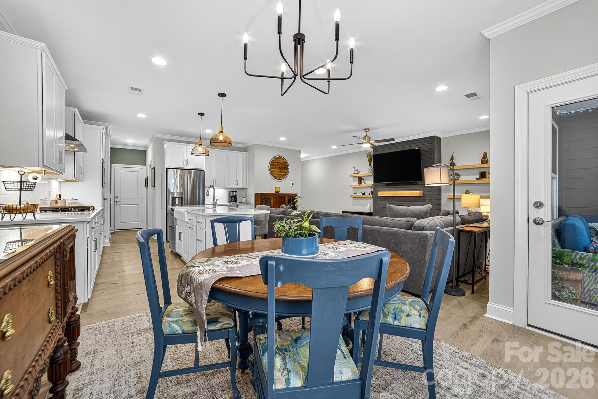 Practically new townhome with stylish upgrades and a private, tree lined setting! The main level features an open floor plan with a beautifully enhanced great room showcasing a custom electric fireplace with shiplap and mantle. The gourmet kitchen offers quartz countertops, sleek white cabinetry, under-cabinet lighting, high-end appliances, and a spacious island, flowing seamlessly to the newly added glass-enclosed rear porch, an inviting extension of the living space. Upstairs includes a spacious primary suite, two additional bedrooms, a versatile loft perfect for a second entertaining area, and laundry with a custom barn door. Outside, enjoy a low-maintenance backyard that backs to mature trees, providing year-round privacy and plenty of room for gardening, grilling, or play. Ideally located just 2.2 miles (6 minutes) to Lake Norman and minutes to the Cain Center for the Arts, shopping, dining, schools, and interstate access, this home blends comfort, convenience, and modern living in one of the area’s most desirable settings!