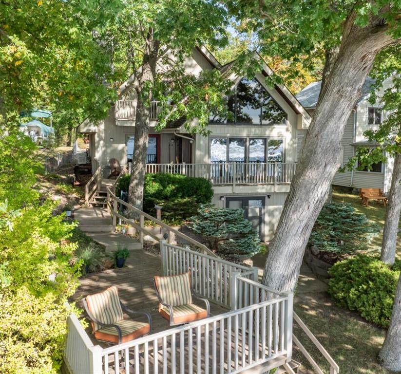 Discover a Rare Opportunity to enjoy a sense of Privacy & Seclusion on the highly sought-after shores of All-Sports DEVILS LAKE! This inviting 3-bedroom, 2.5-bath home offers over 2,450 sq/ft of comfortable living space, complemented by picturesque views that define the property's serene atmosphere. The main floor welcomes you with an open-concept kitchen & living space positioned to capture stunning sunsets year-round, an ensuite bedroom & convenient 1st-floor laundry. Upstairs, two generously sized bedrooms with impressive closet space and a full bath provide plenty of room for family or guests. The spacious walkout basement expands possibilities, ideal for additional living/office space, a workshop & abundant storage. Additional highlights include an attached 2.5-car garage, a whole-house generator and extensive attic storage. This well-built home is a remarkable opportunity to create the lakeside retreat you've always envisioned! Contact the REALTOR today for your private tour!