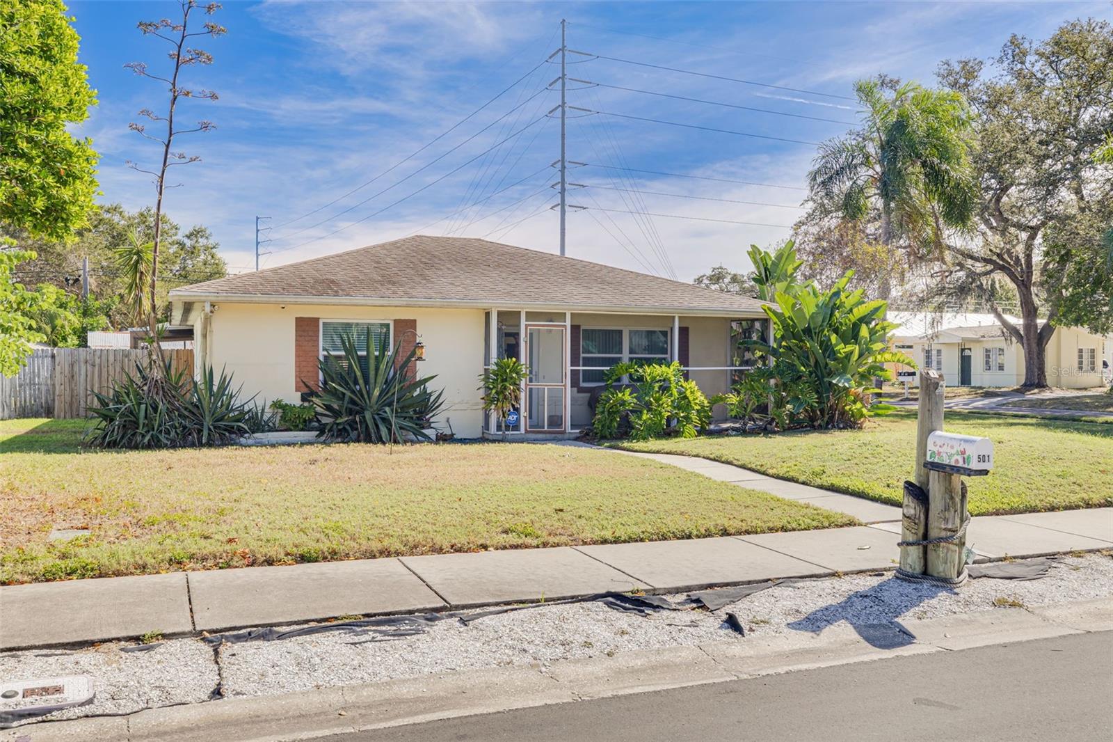 Welcome to this charming 3-bedroom, 2-bathroom bungalow nestled on a spacious corner lot just minutes from Main Street Dunedin, where you’ll find popular restaurants, breweries, and boutique shops—all just a short golf cart ride away! A screened and covered front porch sets the tone for relaxed Florida living. Step inside to discover a bright, inviting living room that offers plenty of space to unwind. On one side of the home, you’ll find a generous primary suite, a guest bedroom with sliding doors to the lanai, and a full bath featuring a walk-in shower with a built-in bench. Toward the back, the open kitchen and dining area create the perfect setting for gatherings, showcasing newer stainless steel appliances and a closet pantry for extra storage. Another bedroom also opens to the backyard lanai, offering versatility as a guest room, office, or hobby space. The garage includes a partially finished bathroom and a finished bonus room—ideal for a man cave, studio, or workshop. Enjoy outdoor living in the fenced backyard, complete with a screened lanai, covered carport, storage shed with a workbench, and ample parking for a boat. Additional highlights include hurricane-rated windows, sliders, and garage door, a newer HVAC system, irrigation system, generator hookup, and a new fence. Don’t miss this well-maintained home that perfectly blends comfort, functionality, and location—just moments from the best of Downtown Dunedin!