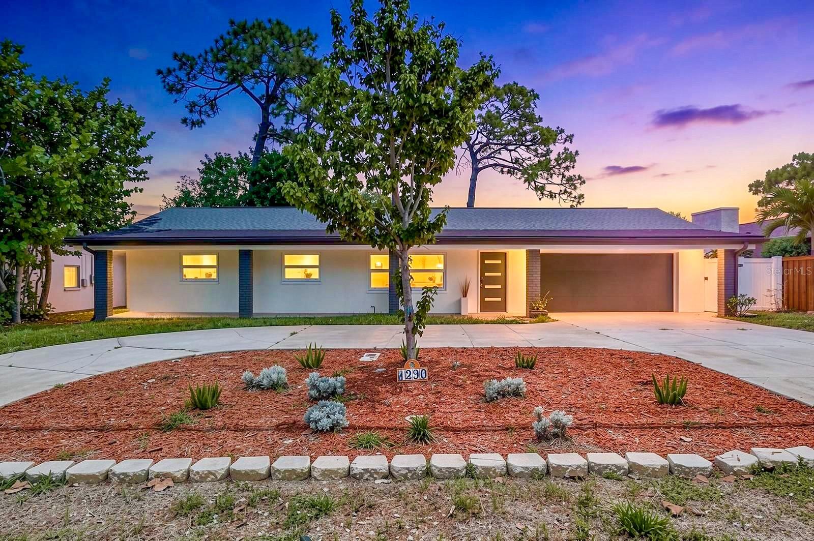 Come see this beautifully REMODELED/UPDATED 4BR/3BA home offering 1,869 sq. ft. of MODERN living in one of Dunedin’s most desirable GOLF CART friendly communities! Located in Flood Zone X – high and dry! NEW ROOF 2025, NEW ENERGY-EFFICIENT WINDOWS AND SLIDING GLASS DOORS 2025, A/C 2017, NEW WATER HEATER 2025, NEW FRONT DOOR 2025, newer GARAGE DOOR (2017), upgraded 200 AMP electrical panel (2013), and no water or storm damage from recent hurricanes. NO HOA or CDD fees!The home features an open-concept kitchen and living room with large new energy-efficient windows that bring in an abundance of natural light throughout the space. The fully renovated kitchen offers a large island, under-cabinet lighting, pendant lights, stainless steel appliances, and sleek modern finishes perfect for entertaining. Luxury vinyl flooring flows throughout the entire home, complemented by modern lighting fixtures and beautifully remodeled bathrooms with tile extending all the way to the ceiling for a clean, upscale look. There is also a spacious dining area surrounded by large windows and sliding glass doors leading to the backyard, creating seamless indoor-outdoor living. One unique feature of this home is the 4th bedroom, which can easily be used as a primary bedroom or a mother-in-law suite thanks to its private entrance, en-suite bathroom, and two walk-in closets. This versatile space could also make a great family room, as it features a cozy fireplace - making it the perfect flex space that can be anything you want it to be.. The home also offers a 2-car garage with an additional 3rd bathroom and a spacious laundry room with extra space for storage. Outside, enjoy the fully fenced backyard, pergola, a shed, and convenient circular driveway making it easy to come and go. This home is just minutes from charming downtown Dunedin with its local restaurants, breweries, boutiques, festivals, marina, and the famous Pinellas Trail. You are also only about 10–15 minutes from the beautiful beaches at Honeymoon Island State Park and the scenic Caladesi Island State Park, known for their crystal-clear Gulf waters, kayaking, nature trails, and stunning sunsets. Nearby parks like Hammock Park and Highlander Park add even more outdoor recreation options, while easy access to Clearwater, Palm Harbor, and Tampa makes commuting and entertainment convenient. This MOVE-IN READY home offers the ideal combination of modern upgrades, prime location, and Florida lifestyle living. Schedule your showing today!