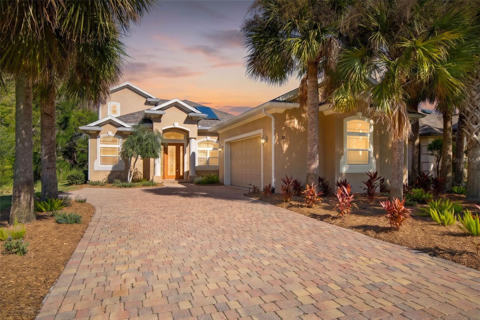 Welcome to 25 Emerald Lake Court, a former Green Construction model home situated on a spacious 0.57-acre homesite in the gated community of Palm Coast Plantation. Backing to protected conservation land along Emerald Lake, This distinctive residence offers 2,820 square feet of living space, four bedrooms, including an upstairs bonus room currently serving as a second primary suite, three full bathrooms, and a separate den, providing exceptional flexibility for everyday living and entertaining.Step inside to discover high ceilings, decorative tray ceilings, crown molding, wainscoting, extra-tall doors, and architectural details that reflect the home's original model-home design. Ceramic tile and laminate wood flooring complement the inviting living spaces, while the kitchen showcases imported Italian cabinetry, granite countertops and backsplash, dark gunmetal-finish appliances, a breakfast bar, and pantry closet.The first-floor primary suite features French doors opening to the screened lanai, a spacious walk-in closet, and a private bathroom with imported Italian cabinetry, dual sinks with a center vanity, a separate soaking tub, and walk-in shower. Upstairs, a versatile bonus room currently serves as a second primary suite, complete with a full bathroom, walk-in closet, and private balcony overlooking the surrounding greenery, with glimpses of Emerald Lake through the trees.Outdoor living is equally inviting, with a screened lanai featuring two ceiling fans and a generous homesite bordered by natural surroundings. A private walkover leads to the property's own fishing dock along Emerald Lake, providing a peaceful place to enjoy the water and observe local wildlife.Additional highlights include a roof replaced in 2022, six replacement impact-resistant windows, a hurricane-resistant garage door, paver driveway, and an air-conditioned two-car garage with epoxy flooring. The home also features attic foam insulation, a hot water booster, an interior laundry room with washer and dryer included, and additional thoughtful improvements.Palm Coast Plantation offers an impressive collection of amenities, including a clubhouse, fitness center, community pool and spa, tennis, pickleball and basketball courts, recreational activities, RV and boat storage (subject to availability), and access to the Intracoastal Waterway. Conveniently located near Flagler Beach, shopping, dining, and Northeast Florida's beautiful coastal destinations, this home offers a distinctive combination of architectural character, flexible living spaces, and natural surroundings.It's More Than a Home. It's a Lifestyle.