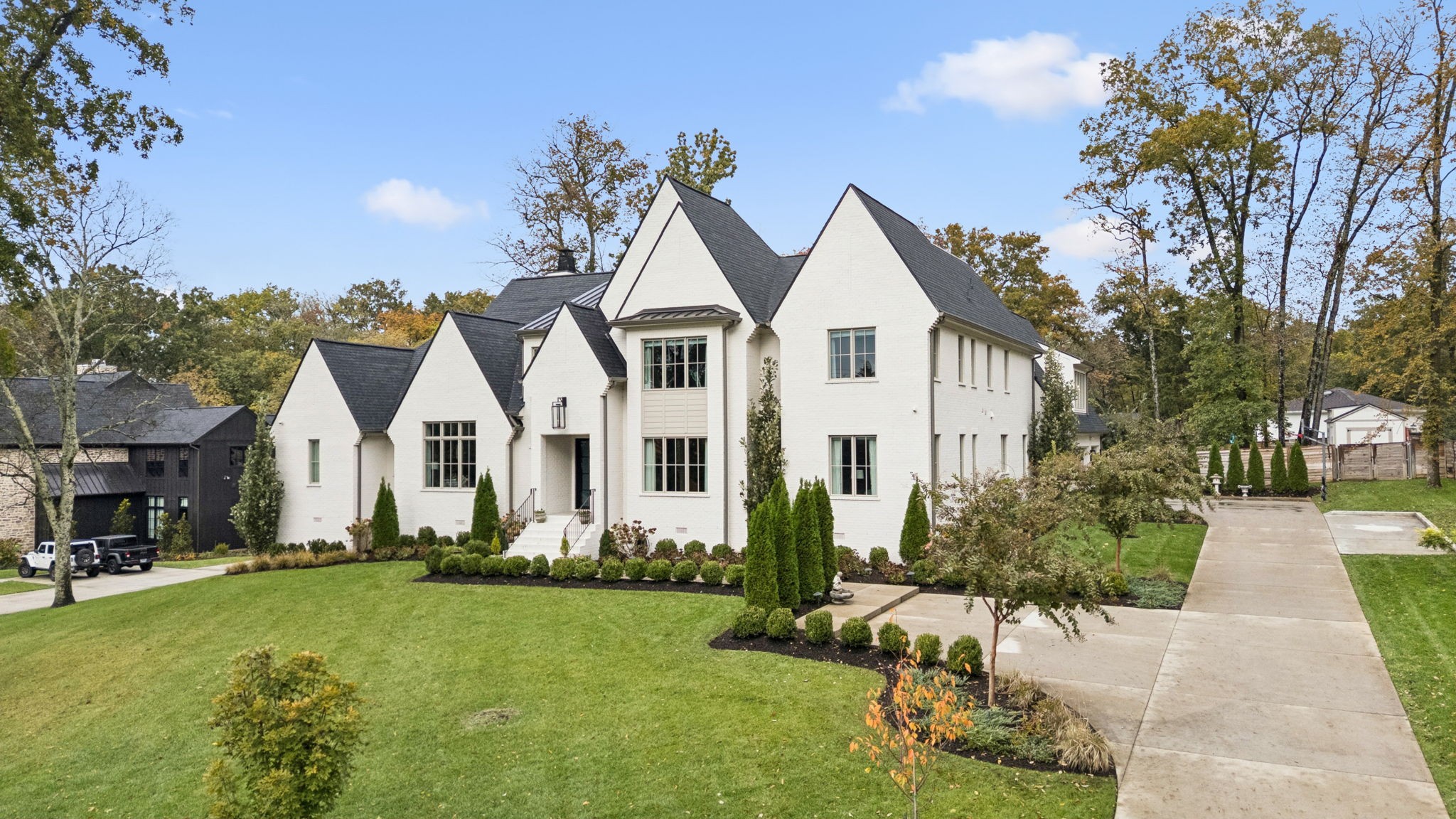 Open House Sunday, November 2, 2-4pm. One-of-a-kind custom, new build, crafted by renowned architect Mitch Barnett and esteemed Metropolitan Builders. Beautifully landscaped acre-plus lot in an exclusive community of Hillwood, combines privacy, prestige, & convenience. This meticulously designed all-brick residence offers 6516 square feet of elegant living space, with 6 spacious bedrooms, 6 full bathrooms, & 2 powder baths, making it the perfect blend of luxury, comfort, & functionality. Enjoy hardwood floors & exceptional architectural details throughout. The main-level primary suite is a luxurious retreat with vaulted ceilings, a spa-inspired bath, & spacious primary closet. Each of the additional bedrooms boasts its own private ensuite bath and walk-in closet. Designed for entertaining & elevated everyday living, the home features a gourmet kitchen outfitted with premium Thermador appliances, seamlessly connected to open-concept living & dining areas. A scullery kitchen has an additional refrigerator, dishwasher and sink, plus extra storage.  The spectacular outdoor living area, featuring a covered patio with fireplace and outdoor kitchen, extends your living space outdoors, overlooking a stunning saltwater heated gunite pool & jacuzzi spa providing your private backyard oasis. The first level features a dedicated office space, perfect for remote work, plus a guest suite. Upstairs comprises 4 bedroom suites and a large media room, which could be used for a playroom or 2nd level den. The oversized three-car garage also includes room for storage. High-end upgrades include motorized shades in the primary & guest bedrooms and motorized black out shades in the media room. Perfectly positioned in Hillwood, this luxury home is just minutes from shopping, restaurants, major interstates, downtown, Warner Parks & the best private schools. The home is equipped with an EV Charger, generator, radon abatement system with sensor & whole house water filtration system.