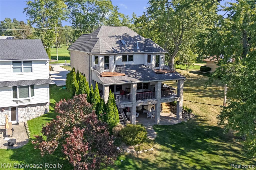 LAKE LIVING AT ITS FINEST ON PRIVATE - ALL SPORTS - LOWER STRAITS LAKE! Located in desirable Edgewood Park Golf Community, this fantastic home offers spectacular views of the lake from one side of the home and private golf course views from the other! The home's open floor plans provides over 4,300 SF of luxuriously appointed Living Space. A raised, covered entry leads to the Foyer featuring a gorgeous staircase with wrought iron balusters. Beyond the Foyer lies a spacious Great Room with stone fireplace and Dining Area with 8' door-walls opening to the covered veranda featuring a built-in BBQ with Prep Station and lake views. The Island Kitchen is furnished with custom cabinetry, granite counters, double wall ovens, snack-bar and pantry. Generous in size, the Owner's Suite features a stone fireplace, balcony, walk-in closet with organizer and Ensuite with dual sink granite vanity, luxury jet tub and huge shower. The 2nd floor includes three additional Bedrooms, full Bath, convenient Laundry Room and a large Bonus Room. Beautifully finished, the lower level walk-out includes a snack-bar Kitchenette, Bedroom, Full Bath and Family Room w/door-wall opening to the covered Paver Patio overlooking the sandy shoreline. The oversized 3 Car Garage is finished with drywall, paint, insulated overhead doors, service doors and a service staircase leading to the LL.