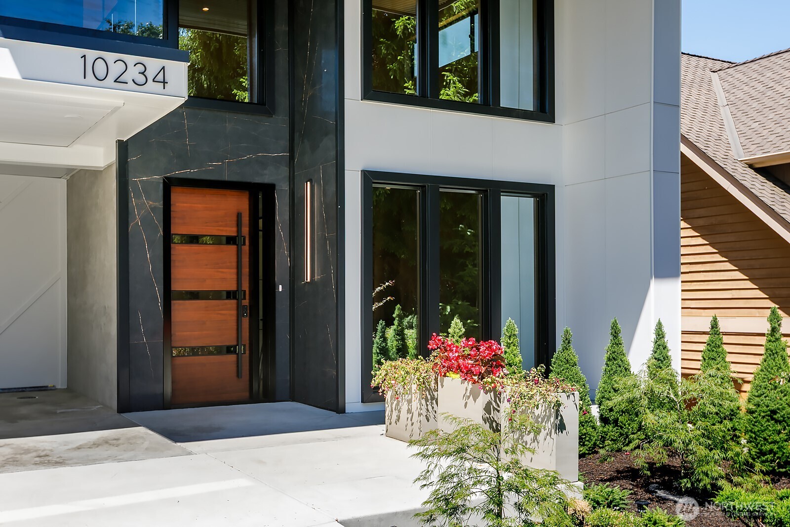 A statement of modern luxury in coveted Clyde Hill, this exceptional 6,323 SF custom residence was designed to deliver something increasingly rare on the Eastside: extraordinary space, thoughtful functionality, and elevated design in one remarkable home. Across three beautifully finished levels, the residence offers 5 generously scaled bedrooms and 6.5 baths, including private en-suites, a dedicated office, multiple living and flex spaces, and exceptional versatility for everyday life and entertaining. At the heart of the home, a dramatic great room pairs soaring ceilings and walls of glass with striking architectural details and an effortless connection to the surrounding outdoor spaces. The expansive kitchen and entertaining areas are designed for gathering, while generous front and rear terraces extend the living experience outdoors. Every level has been thoughtfully considered for comfort and flexibility. The lower level features a private entrance and additional living spaces, creating an ideal setting for extended stays, multigenerational living, guests. Heated bathroom floors and a whole-home ERV fresh-air system further elevate everyday comfort and reflect the home's wellness-focused design. With abundant spaces to work, entertain, retreat, and recharge, this is a home designed not simply for how you live today, but for how life evolves. Ideally situated near top-rated Bellevue schools, world-class shopping and dining, and the best of the Eastside.