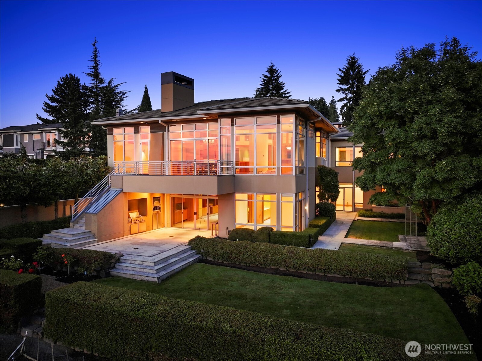 This luxury home boasts a rare bluff setting w/ one of Kirkland’s best views. Designed by Robert Reed, it blends modern PNW architecture w/ Mexican designs inspired by Luis Barragán & Ricardo Legorreta. Built by Bender Chaffey, it features 36” thick angled stucco/metal walls. The 6 BD, 5.5 BA, 5,500 SF home includes an entry w/ a fountain, indoor courtyard w/ fireplace, real stucco, natural stones, & doors like modern Mexican homes. It offers high ceilings, large windows, built-ins, multiple courtyards, a living room w/ fireplace, formal dining, nook, exquisite kitchen w/ views, deck, primary bedroom w/ spa-like bath, 2 offices, rec room w/ kitchenette opening to patio, study/library, craft room, beautiful gardens, & a 3-car garage.