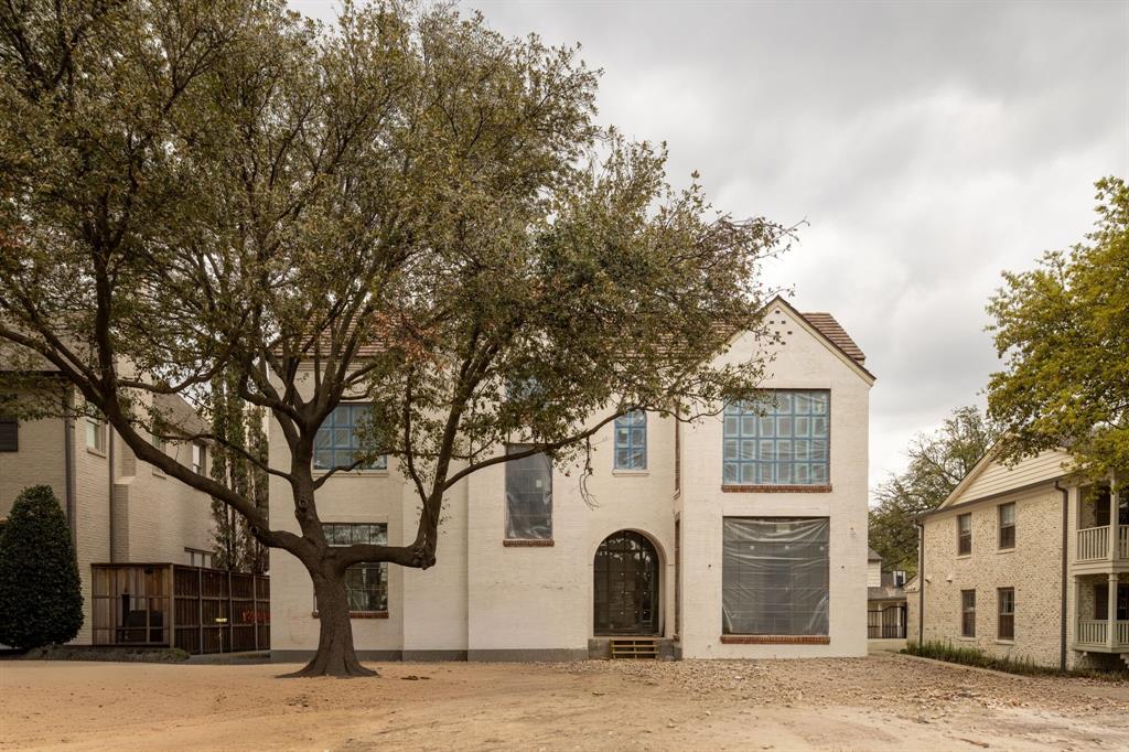 A rare offering by Jarrett Construction on a premier 70x150 lot, zoned to Hyer Elementary. Designed by Jason Luter Architects, this pre-completion opportunity delivers a level of architecture, materials, & execution rarely seen in today’s market. Slurry brick, a tobacco-colored clay tile roof, & an arched steel front door establish a timeless presence, while floor-to-ceiling Lepage windows & doors flood the interiors with natural light. Pier & beam construction underscores the integrity of the build. Inside, 7-inch wide rift & quartered white oak floors anchor a series of refined spaces. The gallery entry makes an immediate statement with herringbone brick flooring & a tongue-and-groove white oak ceiling with beam detail. The dining room is elevated with parquet hardwoods, a cove ceiling, & hand-applied plaster finish. A true focal point, the showcase bar sits between the entry & dining, complete with floating marble shelves & wine refrigeration.The kitchen blends function & design with a walnut island, custom cabinetry, Wolf & Sub-Zero appliances, scullery, & dedicated breakfast room.Living spaces open seamlessly to the outdoor loggia with automatic screens,in-ceiling heaters,& an Isokern fireplace overlooking the pool & spa.Mature landscaping & turf create a private, low-maintenance setting.The study features built-ins,a coffered ceiling,designer wall coverings,& pool views. A flexible downstairs suite serves as a guest retreat or pool cabana-lounge,complemented by a full pool bath.Additional spaces include a mudroom with built-ins & a discreet pocket office with secondary laundry.Upstairs offers dual staircases, elevator-ready design, gym, playroom, & a third-floor bonus space with full bath—ideal as a sixth bedroom or additional living.The vaulted primary suite includes a sitting area & spa-inspired bath. All secondary bedrooms offer en-suite baths & walk-in closets. Custom homes at this level, in this location, rarely come available—unless they’re commissioned.