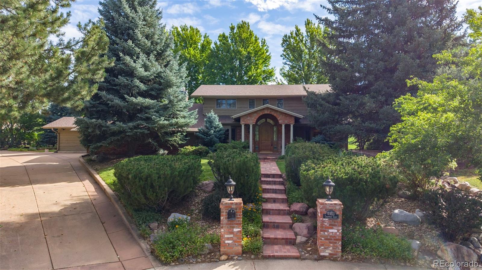 OPEN SUNDAY 1-3 PM! Perfectly situated at the end of a quiet cul-de-sac, this home is surrounded on 3 sides by mature landscaping, with the 4th/back side overlooking Boulder Country Club's Par 3 Golf Course, creating its own private oasis. On a .44-acre lot, this home offers over 5,500 SQFT of thoughtfully laid-out living space, which has been remodeled for everyday comfort and a truly one-of-a-kind first floor entertainment space. Upstairs, you'll find four spacious bedrooms, including a luxurious primary suite complete with its own private sitting room - the perfect spot for morning coffee. Rich hardwood floors flow throughout the main level, complemented by fresh paint and new carpet. The kitchen features rich granite countertops, a large island, breakfast bar and custom built-in appliances, while the great room bar makes for an exceptional gathering space. Enjoy the hearth room's morning sun, or venture into the study to discover secret stairs behind a wood panel. A hidden wine cellar and tasting room awaits you below. The arched, cave-like structure offers a fun environment for entertaining and collecting. Step outside to an expansive covered patio with sweeping golf course views. This relaxing space offers a built-in grill, tranquil water feature, and fireplace. A two-car garage with extra room for two golf carts, and a separate, attached single-car garage provide ample space for a workshop, or extra storage. The finished basement adds a spacious fifth bedroom and bath with additional flexible living space. Walking distance to Boulder Country Club, and moments from Niwot Market and Gunbarrel's favorite local shops, restaurants, and breweries - this is one you simply must experience in person.