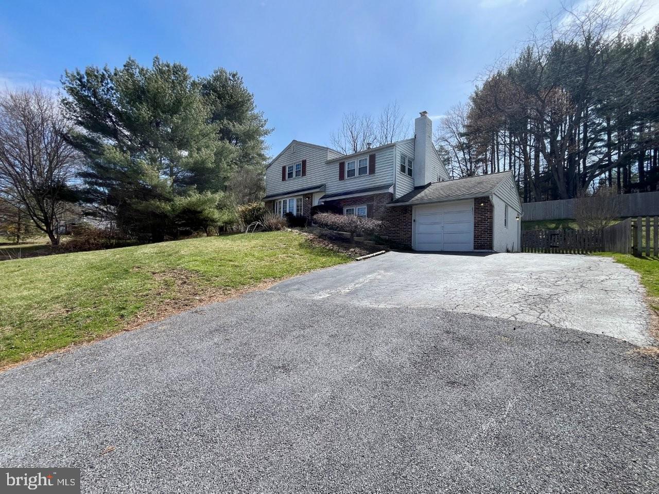 Spacious 4-bedroom split level colonial in West Bradford Township, located in the coveted Downingtown School District with a West Chester address and low taxes. Situated on a picturesque 3/4 acre fenced lot with public sewer and water, this home looks cozy and compact from the exterior, but is much more spacious than it appears! Enter to find a beautiful dining room with gorgeous view from the large bay window (room could also be used as a living room), hardwood floors which open to an updated kitchen with granite counters and a large island with seating overlooking a bright and airy all-season sunroom with wall to wall windows. Lower level has a family room with a fireplace, a full updated bath, plus laundry room with storage and garage entry. Step down to find a pantry, a rec room/playroom, plus a utility/storage area. The upper levels have beautiful hardwood floors throughout. Second level includes two nice size bedrooms and a full bath, leading up to the third level with large master bedroom, above attic storage, plus an additional 4th bedroom. Off the sunroom you ll find a large open deck with private view of the wide-open yard and a retractable awning! A must-see single home with privacy, scenic views, spacious rooms and plenty of storage at a great value! Property sold As Is, Where Is, Buyer will be responsible for any certifications needed. Some images in this listing have been virtually staged.