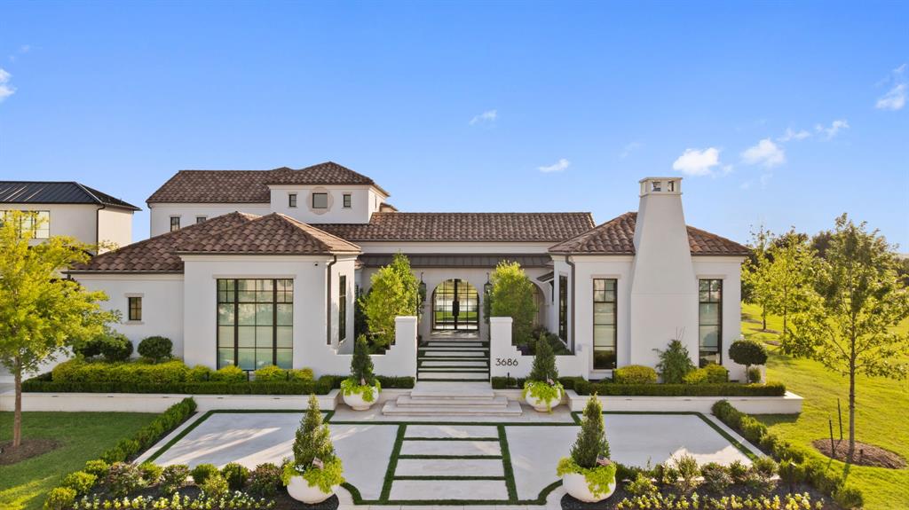 This exceptional corner-lot residence is gracefully surrounded by two acres of lush HOA green space, set deep within the prestigious guard-gated enclave of the Hills of Kingswood. Thoughtfully designed courtyards anchor both ends of the home, one offering a warm welcome, the other inviting you to stay a while. Symmetry and sophistication define the exterior. Manicured landscaping frames a pool that feels as though it glides rather than rests. The home’s east-facing orientation welcomes soft morning sun and allows natural light to pour in throughout the day, enhancing the home’s warmth and brightness. Inside, the experience unfolds through a dynamic play of light and shadow. Coffered ceilings float above paneled walls, and statement marble fireplaces casually steal your attention. Ralph Lauren lighting and Kallista bath fixtures elevate the interiors, while bespoke millwork and refined finishes speak to a level of craftsmanship rarely seen today. A standout feature of this residence is the secondary primary suite privately positioned with its own dedicated entrance. Inside, a custom fireplace sets a wonderful ambiance, complemented by a bar with built-in cooling fridge, marble clad en-suite bath, and a discreet Miele washer and dryer for effortless convenience. It’s the perfect space for long-term guests, multigenerational living, or an elevated work-from-home retreat. Smart home technology is seamlessly integrated throughout. A whole-home water filtration system, hard-wired security, a storm shelter built into the foundation slab, and a standby generator provide both comfort and confidence. The kitchen is architecturally sharp, designed with purpose and presence. Every fixture, every finish, every subtle shadow contributes to the feeling this extraordinary residence has. There’s a quiet power here. A calm rhythm. A sense that everything is exactly where it belongs.