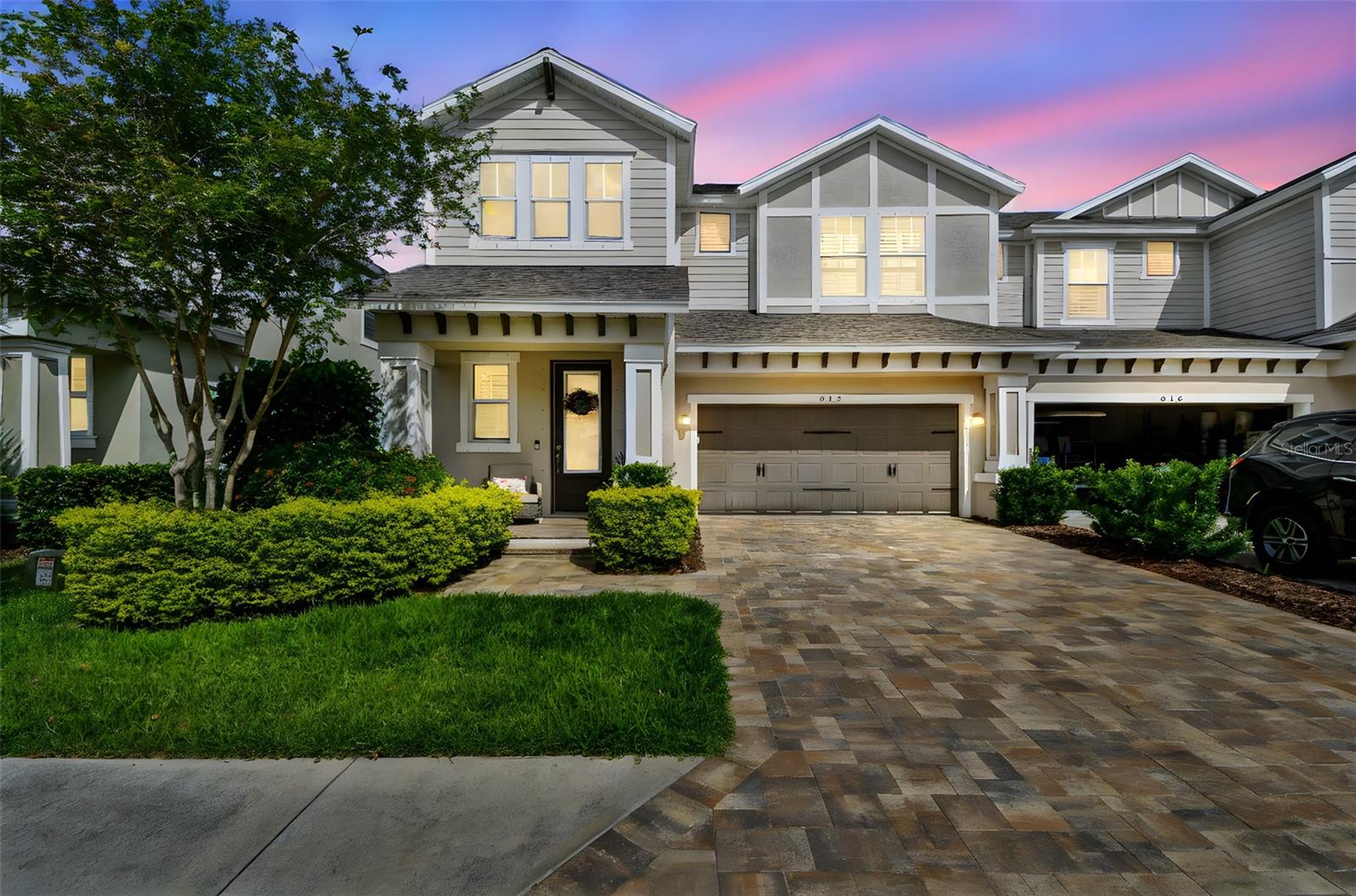 Positioned just steps from the clubhouse and pool, and set on a prime pond-view lot in Ozona Village, this 3-bedroom, 3-bathroom townhome offers a rare combination of thoughtful upgrades, pristine condition, and low-maintenance living in one of Palm Harbor’s most walkable coastal communities. The exterior was just freshly repainted, and the HOA is decreasing to $500 monthly. Built in 2019 and carefully maintained ever since, the home offers over 2,300 square feet of living space with an intuitive layout and tasteful finish selections throughout. Rich dark laminate flooring anchors the main living areas, while upgraded carpeting with plush padding brings comfort to the bedrooms. The kitchen is both elegant and efficient—featuring an extended counter-height island with elegant Carrera quartz, soft-close cabinetry, a built-in oven and microwave, wine fridge, cooktop with range hood, and a striking glass backsplash. The main floor includes a private bedroom and full bath, ideal for guests or multi-generational living. Upstairs, a versatile loft space serves as a dedicated work zone or study nook. The primary suite is a standout, with tray ceilings, a custom walk-in closet, and a serene pond view. Closets throughout the home include smart storage systems, and the upgraded staircase adds a subtle architectural accent. Step outside to the extended lanai—clean lines, a tranquil water view, and ample green space create an easy backdrop for morning coffee or evening conversation. Behind the scenes, this home is equally well cared for: pavers are professionally cleaned, sealed, and sanded yearly; the HVAC system is serviced annually and now includes a HALO UV purification system (2025); and fresh interior paint (ceilings and main floor, 2025) ensures a turnkey experience for the next owner. Flood insurance isn’t required (X zone), and the property has remained unaffected by recent storms. Located within one of the top-rated school zones in the state and just minutes from the coast, the home also sits in the heart of Ozona’s vibrant golf cart district—where marinas, live music, and the Pinellas Trail are all part of daily life. For those seeking a low-maintenance home without compromise, 612 Ozona Village Dr delivers on every level.