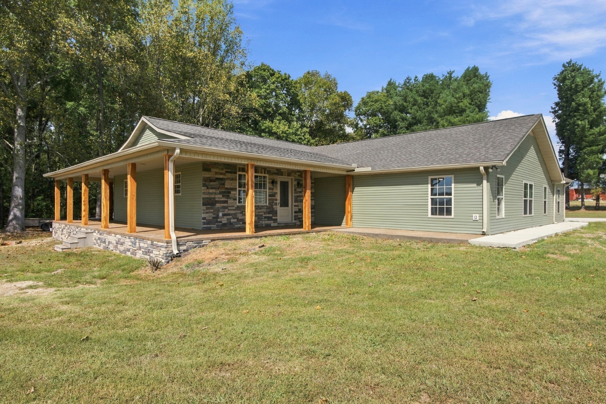 Escape to peaceful country living in this beautifully remodeled 3-bedroom, 3-bath home, perfectly situated on a spacious 2.01-acre corner lot with breathtaking views. From the moment you arrive, the gorgeous wraparound porch invites you to slow down, relax, and take in the beauty of the surrounding countryside. Inside, you'll find a fresh updated interior featuring beautiful tile flooring, spacious living areas, and thoughtful finishes throughout. With 3 bedrooms and 3 full baths, there's plenty of room for family and guests. The oversized 2-car garage offers exceptional space for vehicles, storage, hobbies, or a workshop. Outside, the generous acreage provides room to spread out, entertain, garden, or simply enjoy peace and privacy of country life. If you've been dreaming of a move-in-ready home with acreage, beautiful updates, and that hard-to-find country setting, this one checks all the boxes. New roof, new siding, 1700 sq ft of new tile and so much more.