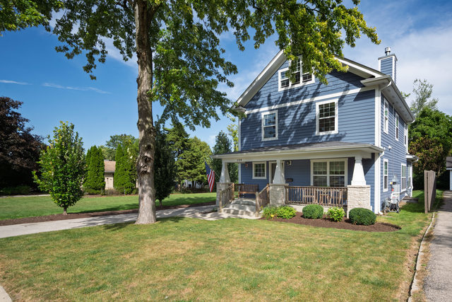 Farmhouse Charmer with pond and trail views! 4 Bedroom, 2.5 baths,  Finished 3rd Floor. This is a beautifully maintained 2016 home. The welcoming front porch leads to the pretty center entry. The most desired features include light hardwood floors throughout first floor, white woodwork, volume ceilings and custom raised hearth stone fireplace in the living room. Enjoy a first-floor office/bedroom, beautiful custom kitchen that features white cabinetry with 42" uppers, granite countertop, stainless steel appliances, farm sink, center island and walk in pantry. Off the kitchen is the mud/laundry room with exterior access. The spacious family room with stone fireplace adjoins the dining room that overlooks the back yard. Plus a first floor bedroom/Office and powder room. The second floor includes luxury master bedroom with hardwood floors, walk in closet and spacious private master bath. Two additional bedrooms feature their own hall bath. Finished third floor is light and bright and can be a fifth bedroom, office or play room. Oversized 2 car garage is set up with Level 2 EVC and Solar Panels that serve as off grid power source! Mature trees in the backyard overlook 14 acres of ponds for fishing and kayaking, plus walking trails. The Prairie Path has plans to annex the area. Great location with easy access to all transportation.