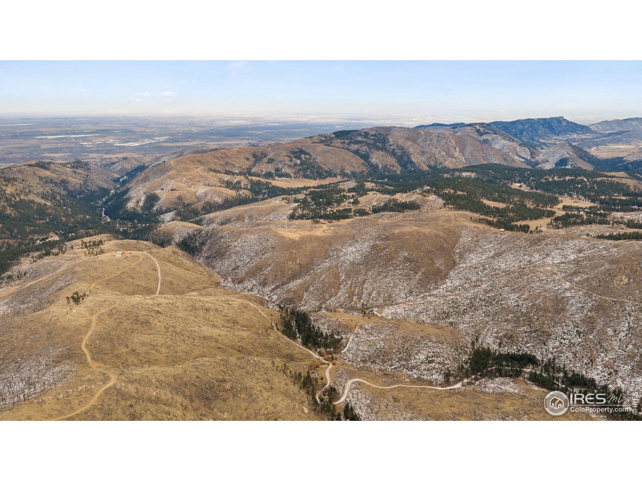 Set on 55 acres with open zoning in Larimer County, this exceptional property offers a rare opportunity to build in a peaceful, private setting with expansive views. Horses and livestock are welcome, and there is no HOA, providing flexibility and freedom of use. The land is ready for development with an existing foundation, electrical service already in place, and an additional electric meter installed at a future shop location. A buried 500-gallon cistern is on site, supporting immediate building plans.The property was impacted by a prior fire, with burned trees cleared and healthy new growth now established, creating open sightlines and a renewed landscape. Sheltered from prevailing winds, the setting is quiet and serene, ideal for a custom home, equestrian property, or private retreat. A unique chance to own acreage with infrastructure already in place and the ability to build your vision.