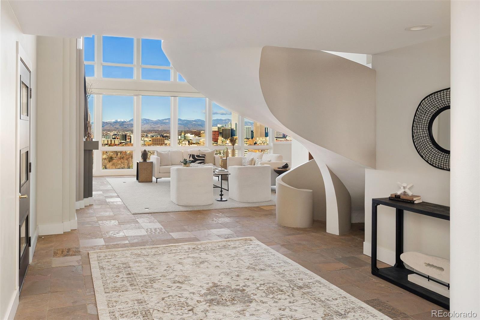 A RARE CHEESMAN PARK PENTHOUSE WITH A PRIVATE 1,800-SQ-FT ROOFTOP TERRACE. Perched directly above Cheesman Park, this exceptional Denver penthouse combines panoramic Denver skyline + Colorado Rocky Mountain views with the privacy, ease + security of boutique high-rise living.Two elevators open directly into the residence, while an internal elevator leads to an expansive 1,800-sq-ft rooftop terrace encompassing nearly half the building’s rooftop and adjacent to the residence pool. Designed for grand-scale entertaining or quiet Front Range sunsets, this extraordinary outdoor space is one of the home’s defining features.Inside, dramatic 20-foot floor-to-ceiling windows frame views of the Denver Botanic Gardens, downtown Denver + the Rocky Mountains. The primary suite features a spa-like five-piece bath with steam shower. A fireside living area flows into a four-season sunroom, creating an inviting space for relaxed living + entertaining.Two garden courtyards, three heated parking spaces, private storage + six-day concierge service complete the lock-and-leave lifestyle. Minutes from Cherry Creek’s dining + culture, with downtown Denver and the city’s best amenities close at hand, this is an extraordinary opportunity for an elevated downsize, seamless mountain-to-city base or sophisticated Denver pied-à-terre. The lock-and-leave dream.
